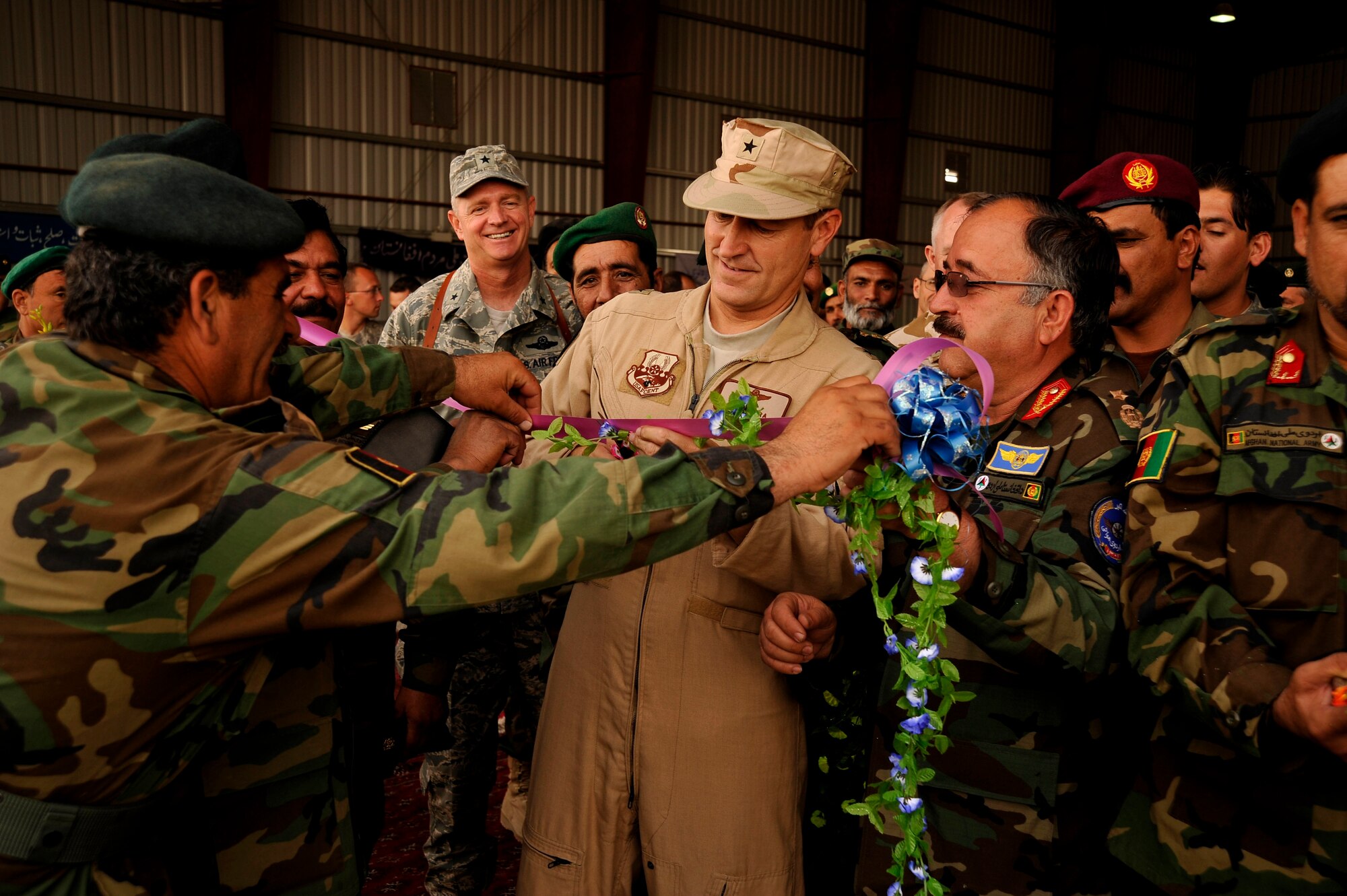 U.S. Air Force Brig. Gen. Mike Boera helps cut a ceremonial ribbon at an Afghan National Army Air Corp wing activation Oct. 5, 2009 at Kandahar Air Field. The wing is the ANAAC's second and supports Mi-17 helicopter operations and training. General Boera is the Commanding General of Combined Air Power Transition Force, Combined Security Transition Command-Afghanistan. (U.S. Air Force photo/Staff Sgt. Angelita Lawrence)