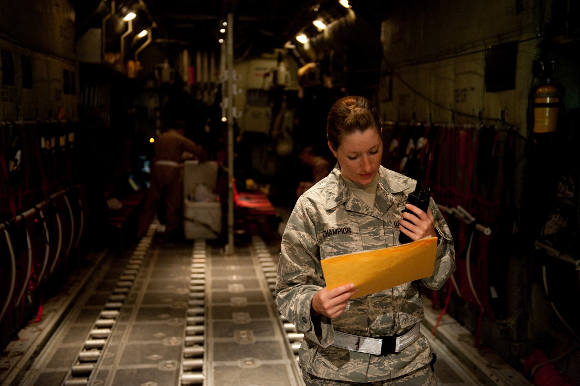 U.S. Air Force Senior Airman Lacy Champion, 8th Expeditionary Air Mobility squadron air terminal operations center controller, checks the cargo and passenger manifest, Oct. 6, in Southwest Asia. Airman Champion helps ensure all local cargo aircraft have their cargo and passenger unloaded and loaded correctly, timely and safely. Airman Champion is deployed from Dover Air Force Base, Del., in support of Operations Iraqi and Enduring Freedom. (U.S. Air Force photo/Staff Sgt. Robert Barney/RELEASED) 