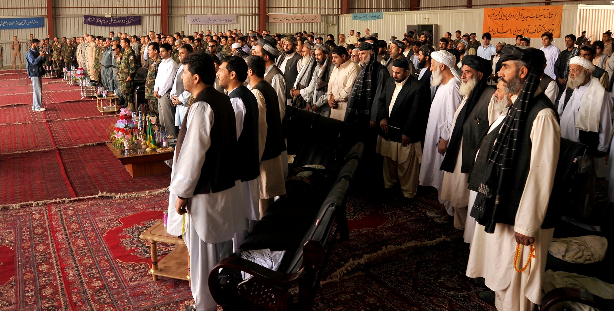 Afghan servicemembers and local dignitaries and coalition partners celebrate the activation a new wing at Kandahar Airfield Oct. 5, 2009. The wing is the second wing to stand up as a part of the Afghanistan National Army Air Corps. The primary missions of the new wing is moving troops and supplies around the region.  (U.S. Air Force photo/Staff Sgt. Angelita Lawrence)