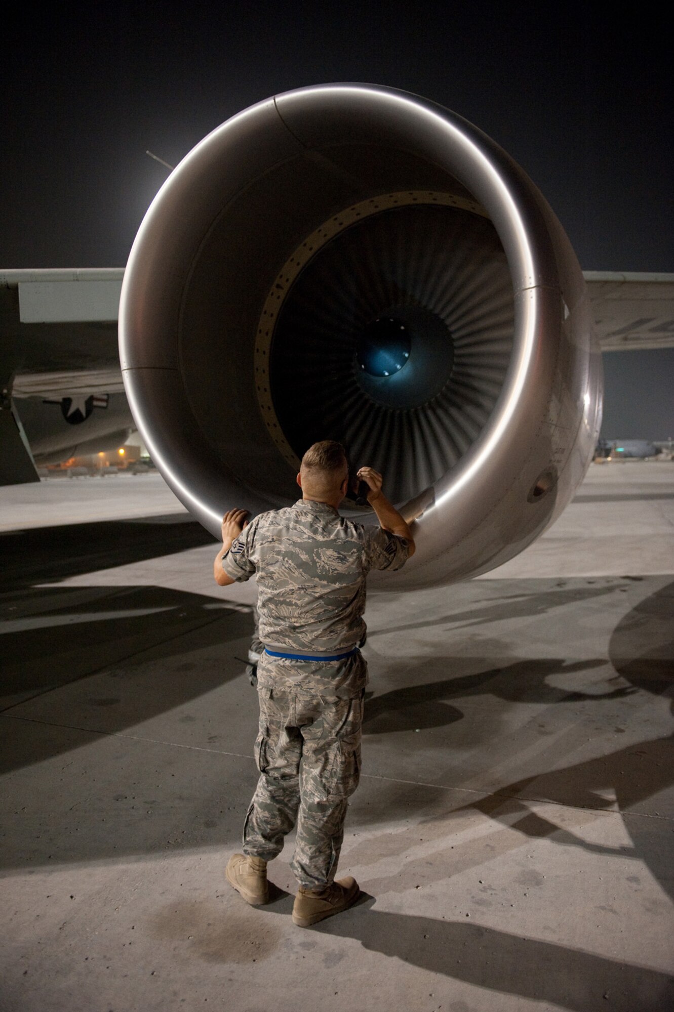 Staff Sgt. Michael Palmer, 55th Aircraft Maintenance Unit, inspects a RC-135V/W Rivet Joint for damage after it returned from a mission, Oct. 7, in Southwest Asia. Sergeant Palmer helped mark Oct. 7 as the 7,000th consecutive day the Rivet Joint has provided commanders in the U.S. Central Command area of responsibility near real-time on-scene intelligence collection, analysis and dissemination. Sergeant Palmer is deployed from Offutt Air Force Base, Neb., in support of Operations Iraqi and Enduring Freedom. (U.S. Air Force photo/Staff Sgt. Robert Barney) 