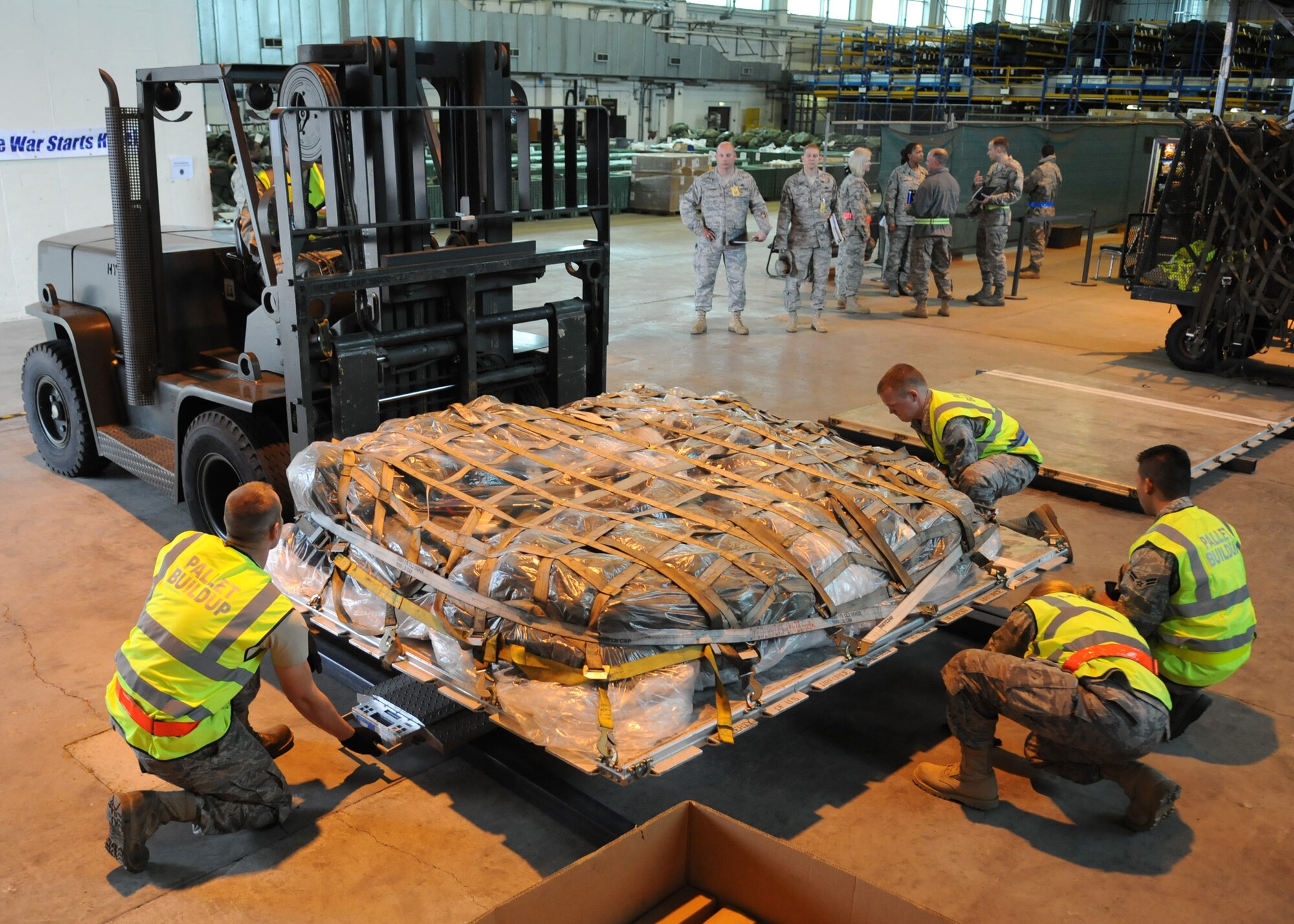 RAF MILDENHALL, England – Airmen with the 100th Logistics Readiness Squadron prepare to weigh a pallet with deployment gear at Building 550 during the Phase I portion of the Operational Readiness Inspection Oct. 7. Airmen practice for possible real deployment scenarios to ensure a smooth transition. (U.S. Air Force photo/ Staff Sgt. Jerry Fleshman)