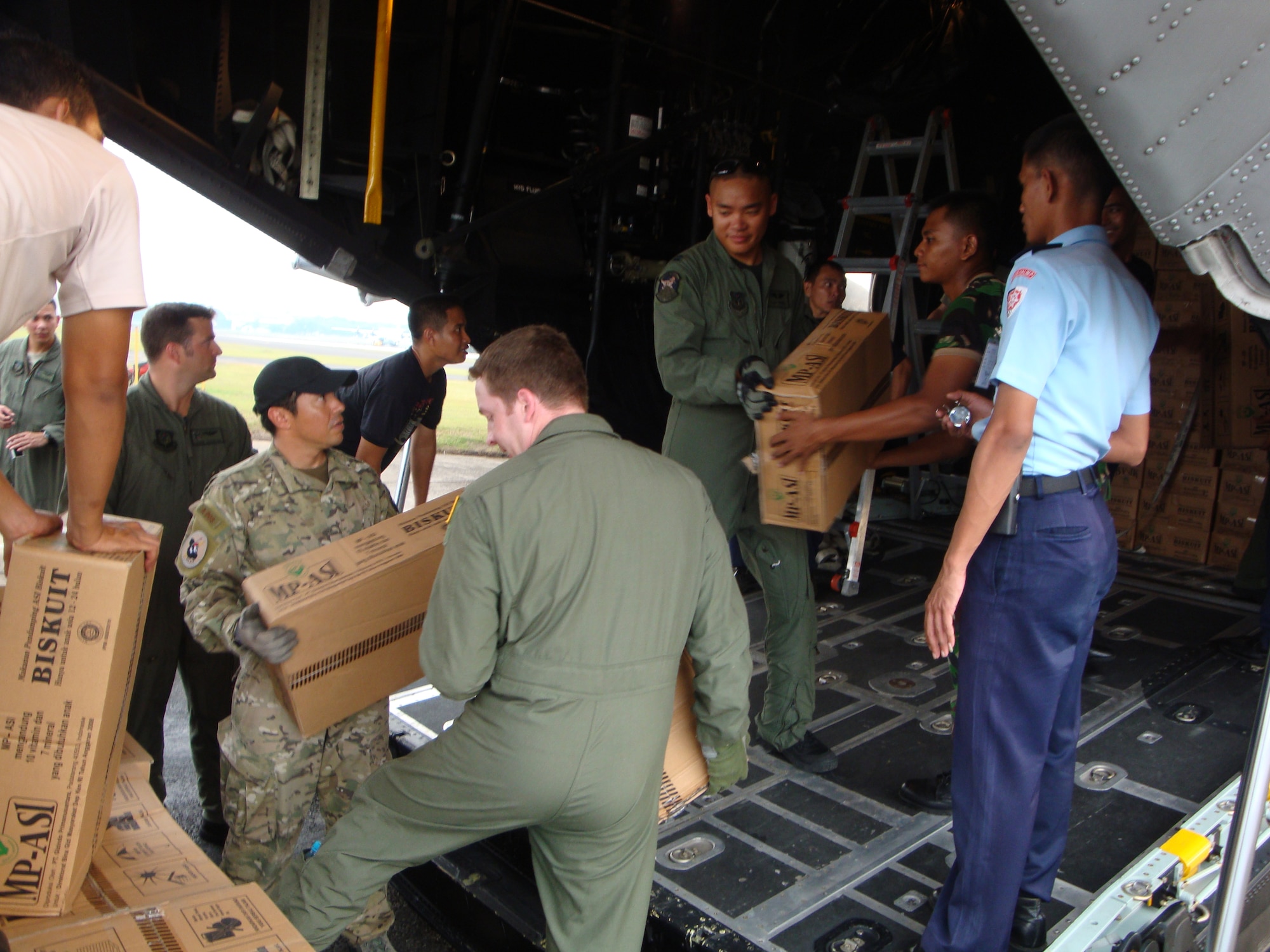 BANDUNG, Indonesia -- Members of the 353rd Special Operations Group and Indonesian Air Force Korpaskhas, a special operations branch of the Indonesian Air Force, load relief supplies on a MC-130P Combat Shadow here supporting humanitarian relief operations near Padang in western Indonesia. MC-130P Combat Shadow aircrews have flown more than 15 flights, moved about 100 people, and more than 160,000 pounds of cargo throughout the affected area.  (Courtesy photo)                                