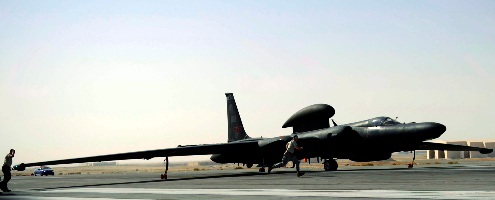 SOUTHWEST ASIA - Airmen quickly remove the final pins from a U-2 Dragonlady before a flight Oct. 4, 2009. The sortie was Capt. Peter J. Gryn's first combat mission. The U-2 is the primary source of high altitude intelligence, surveillance and reconnaissance. Captain Gryn is deployed from Beale Air Force Base, Calif. (Air Force photo/Staff Sgt. J.G. Buzanowski)