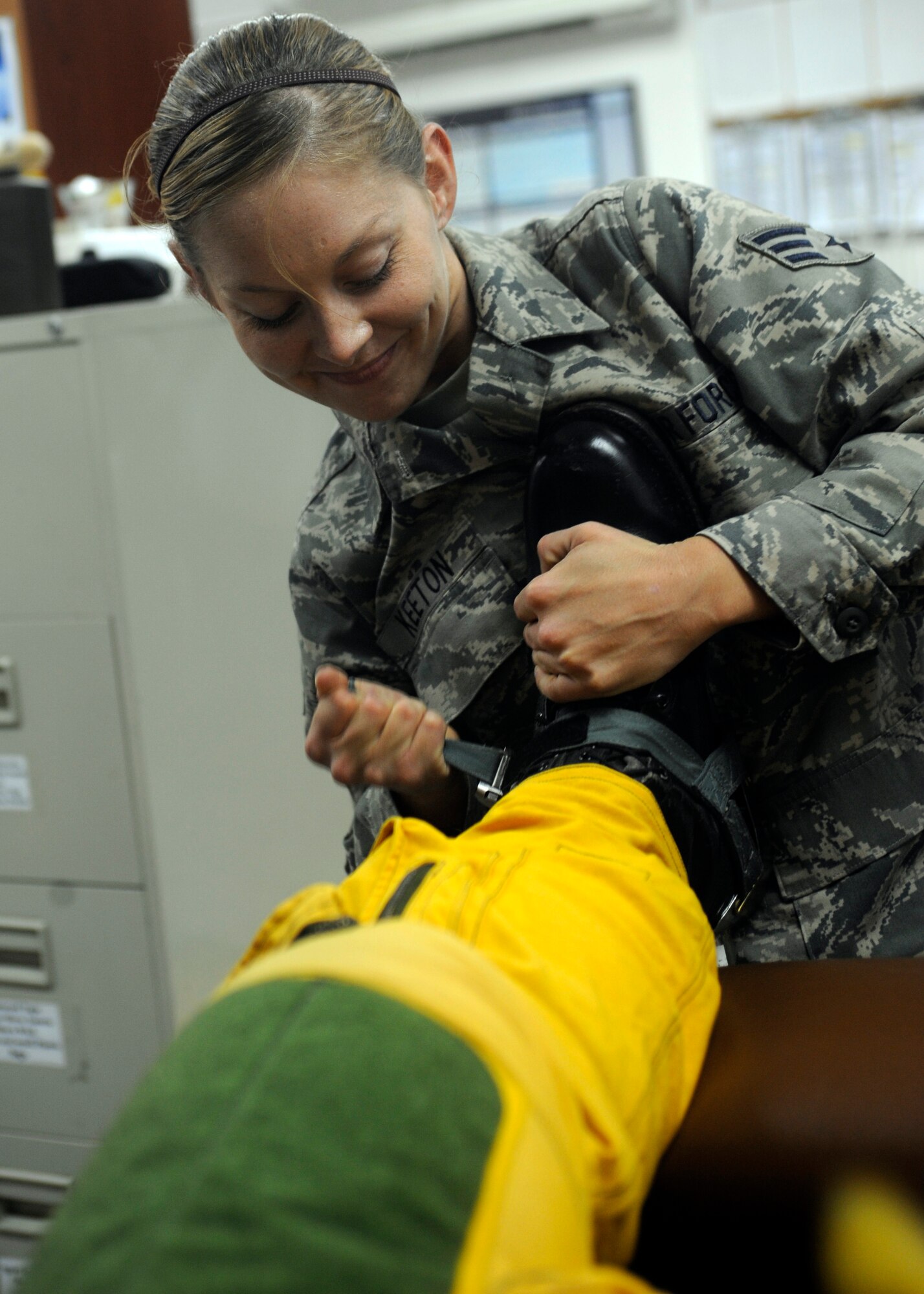 SOUTHWEST ASIA - Senior Airman Lynette Keeton tightens the boots of Capt. Peter J. Gryn's flight suit Oct. 4, 2009. The sortie was Captain Gryn's first combat mission. Both Airmen are deployed from Beale Air Force Base, Calif. (Air Force photo/Staff Sgt. J.G. Buzanowski)