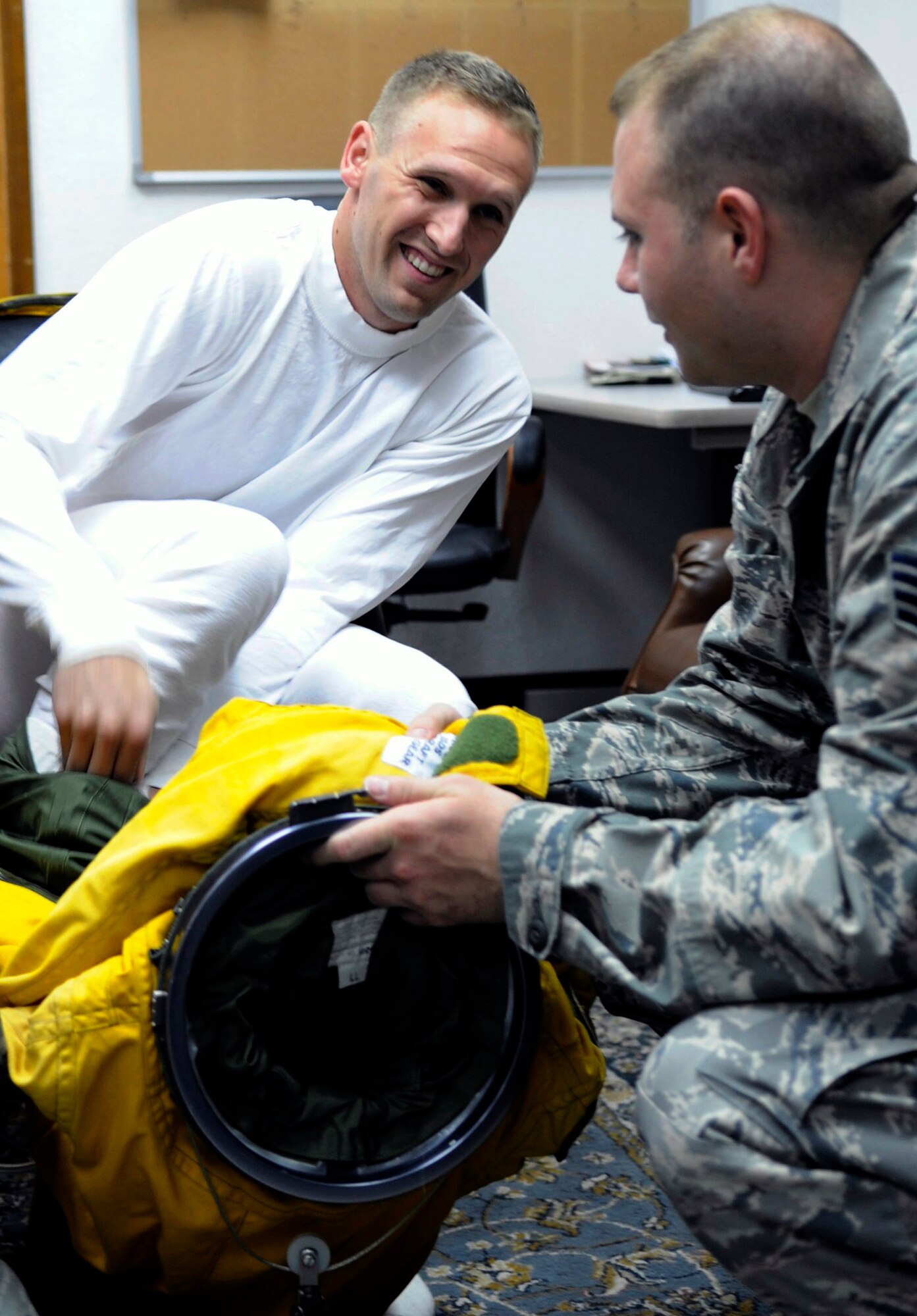 SOUTHWEST ASIA - Staff Sgt. Mark Reith helps Capt. Peter J. Gryn don his specialized suit before a flight Oct. 4, 2009. The sortie was Captain Gryn's first combat mission. Both Airmen are deployed from Beale Air Force Base, Calif. (Air Force photo/Staff Sgt. J.G. Buzanowski)
