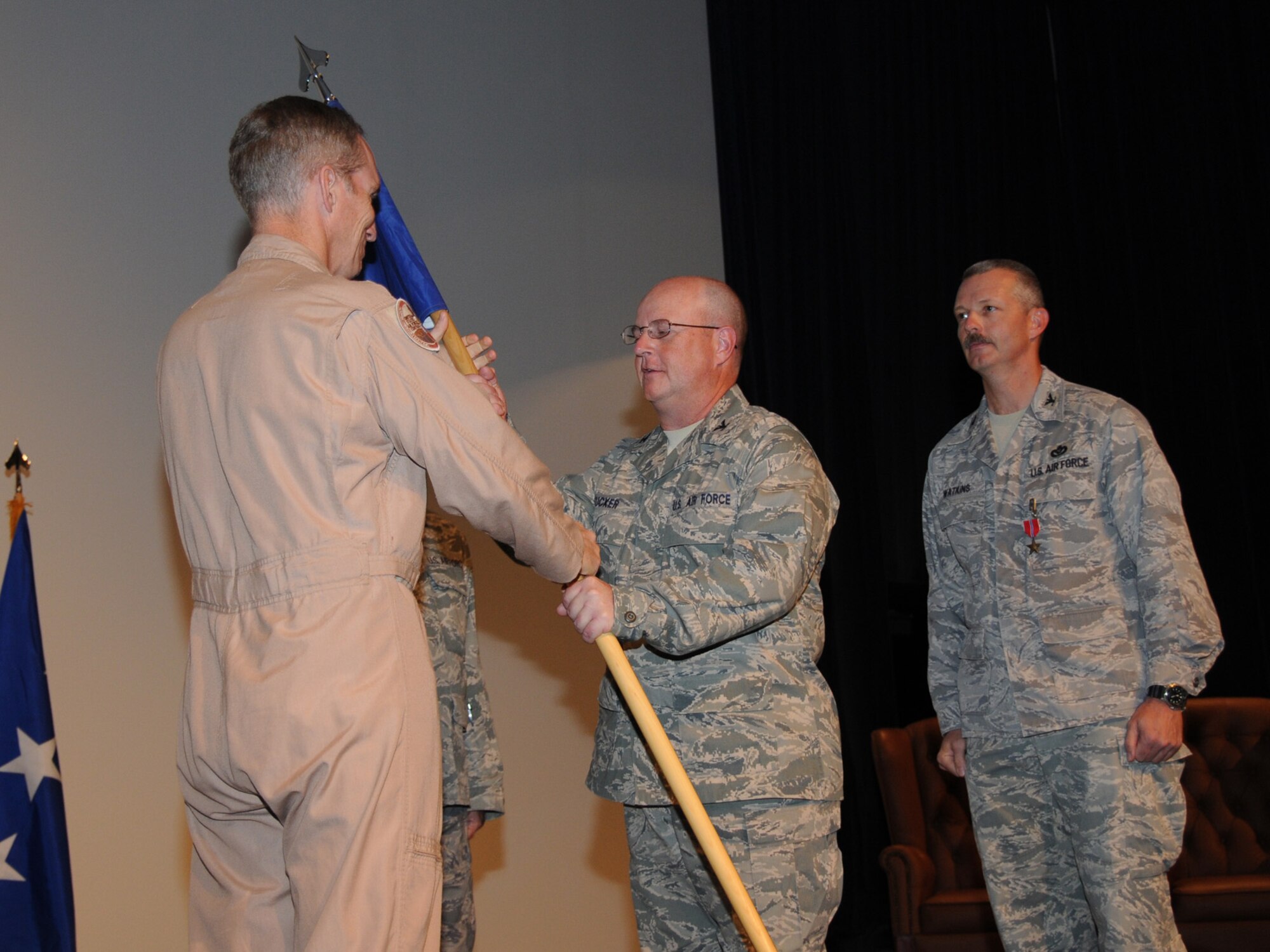 Lt. General Mike Hostage, U.S. Air Forces Central commander, presents Col. Douglas Tucker with the unit guidon as he assumes command of the 1st Expeditionary Red Horse Horse Group at a change of command ceremony here, Oct. 2. Colonel Tucker assumes command from the previous 1 ERHG commander, Col. Terry Watkins. (U.S. Air Force Photo/Tech. Sgt. Jason W. Edwards)