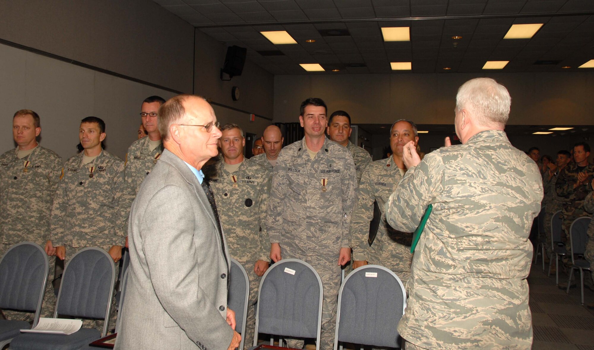 The 19 graduates of the first class of the Delaware National Guard's Delaware Leadership Academy are applauded by Academy Dean Lt. Col. Andrew Hartnett during the Oct. 3, 2009 graduation ceremony held at Del. ANG Headquarters in New Castle, Del. Standing in front, center, is Mr. Steve  Kauffmann. (U.S. Air Force photo/Tech. Sgt. Tracy Childs)