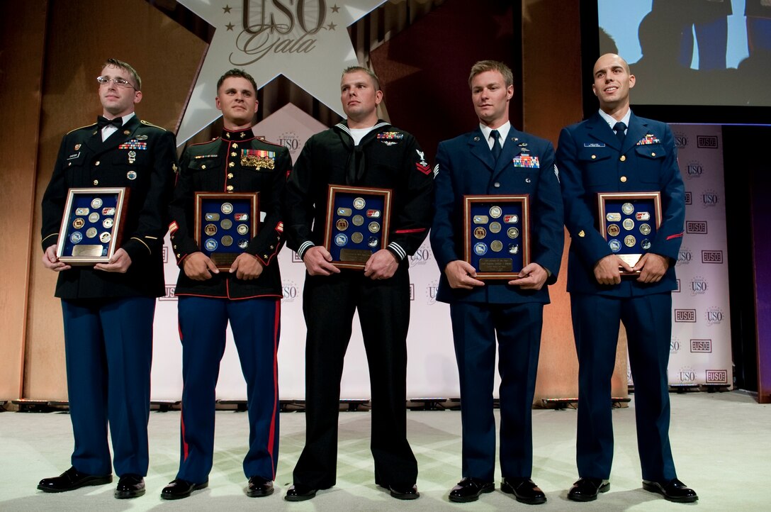 U.S. Army Spc. Michael D. Carter, U.S. Marine Sgt. Mark A. Robinson, U.S. Navy Petty Officer 2nd Class William S. Stevens, U.S. Air Force Staff Sgt. Zachary J. Rhyner, and U.S. Coast Guard Petty Officer 2nd Class Abram H. Heller display the awards they received as Servicemembers of the Year for their individual branches at the 2009 USO Gala, Washington, D.C., Oct. 7, 2009.