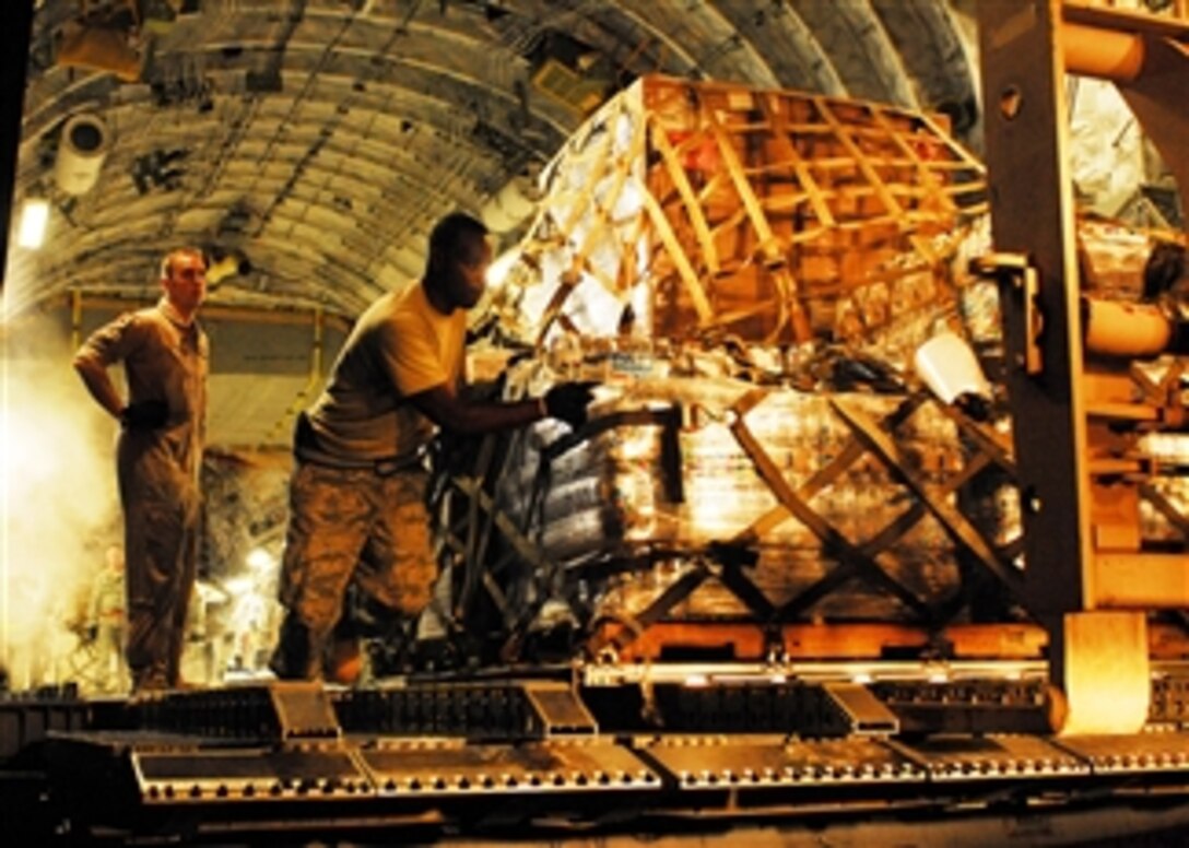 U.S. Air Force Staff Sgt. Brenton Phillips (right) of the 36th Mobility Response Squadron, Andersen Air Force Base, Guam, and Staff Sgt. Norm Metz, a loadmaster with the 517th Airlift Squadron, Elmendorf Air Force Base, Alaska, download a pallet of medical supplies from a C-17 Globemaster III aircraft in Padang, Indonesia, on Oct. 5, 2009.  Phillips is an air transportation specialist deployed to Padang with a humanitarian assistance rapid response team to provide medical assistance to those affected by a recent earthquake.  