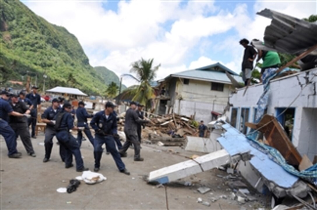 U.S. Navy sailors assigned to guided-missile frigate USS Ingraham (FFG 61) remove a damaged roof during disaster recovery efforts in Pago Pago, American Samoa, on Oct. 3, 2009.  The region was struck by an earthquake and a resulting tsunami.  
