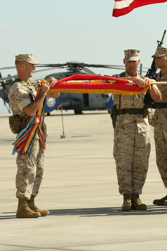 Lt. Col. Thomas C. Euler, the last commanding officer of Marine Medium Helicopter Squadron 161, Marine Aircraft Group 16, 3rd Marine Aircraft Wing, I Marine Expeditionary Force, and Sgt. Maj. Thomas M. Herman, the squadron sergeant major, retire the squadron's organizational colors during their deactivation ceremony aboard Marine Corps Air Station Miramar, Oct. 8. HMM-161 is one of the oldest medium transport squadron in the Marine Corps, serving more than 58 years. (Official U.S. Marine Corps photo by Cpl. Christopher O'Quin)(Released)