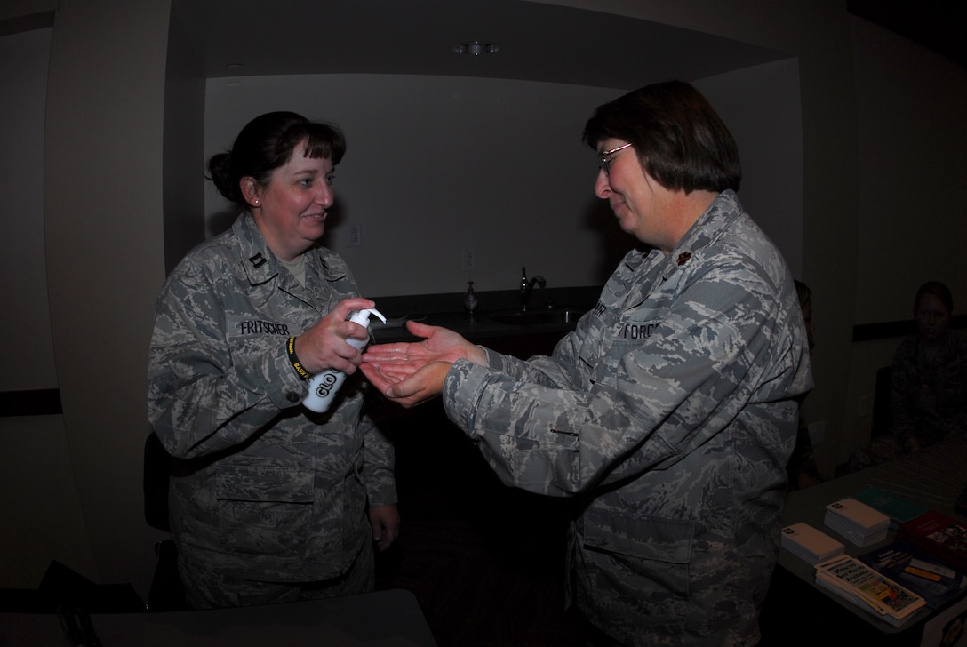 Buckley Air Force Base, Colo. – Capt. Wendy Fritscher and Maj. Vicki Fair, 460th Medical Support Squadron, demonstrates the essentials of good hand washing at the medical booth during the Fall Safety Campaign Oct. 8. (U.S. Air Force photo by Staff Sgt. Anika K. Williams)