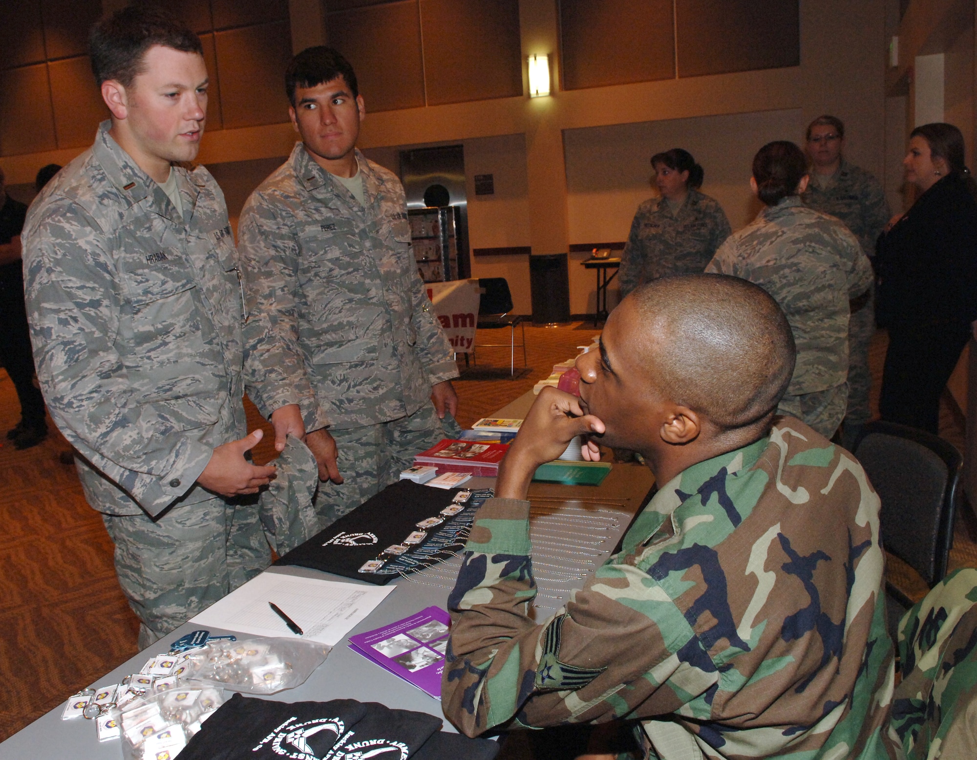 Buckley Air Force Base, Colo.— 2nd Lt. Bruce Hrabak and 1st Lt Juan Perez, 2nd Space Warning Squadron, talk to Senior Airman Darnell Walcott, 460th Space Communications Squadron, about Airman Against Drunk Driving at the Save-a-Life Tour held at Buckley's Leadership Development Center Oct. 8. (U. S. Air Force photo by Tech. Sgt. Shirley Henderson)
