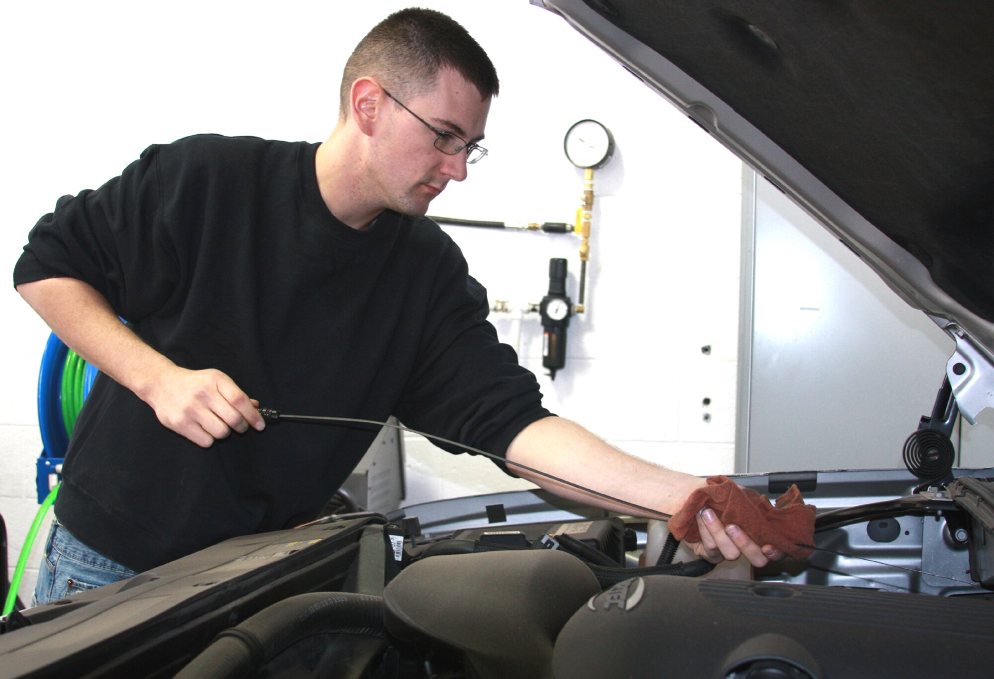Airman Zachary Wynne checks a truck's engine oil during the 341st Logistics Readiness Squadron's winter vehicle inspections Oct. 3. The free inspections resume Saturday from 10 a.m. to 2 p.m. in building 870. (U.S. Air Force photo/Tech. Sgt. Marcus McDonald)