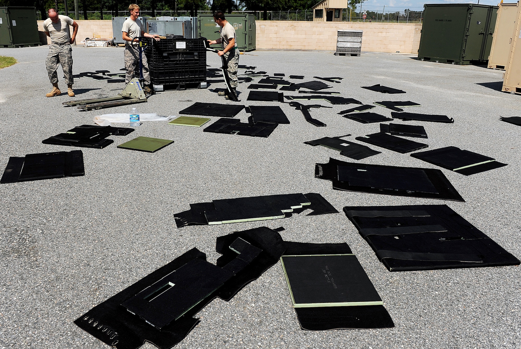 MOODY AIR FORCE BASE, Ga. -- Senior Airman Ricky Taylor, Senior Airman Kelly Sanders and Staff Sgt. Tyler Sorrells, 723rd Aircraft Maintenance Squadron crew chiefs, inspect armor panels from a HC-130P/N Combat King in preparation for an upcoming operational readiness exercise here. The plates have to be checked every time the plane is downloaded to ensure they are not damaged. (U.S. Air Force photo by Airman 1st Class Joshua Green) 