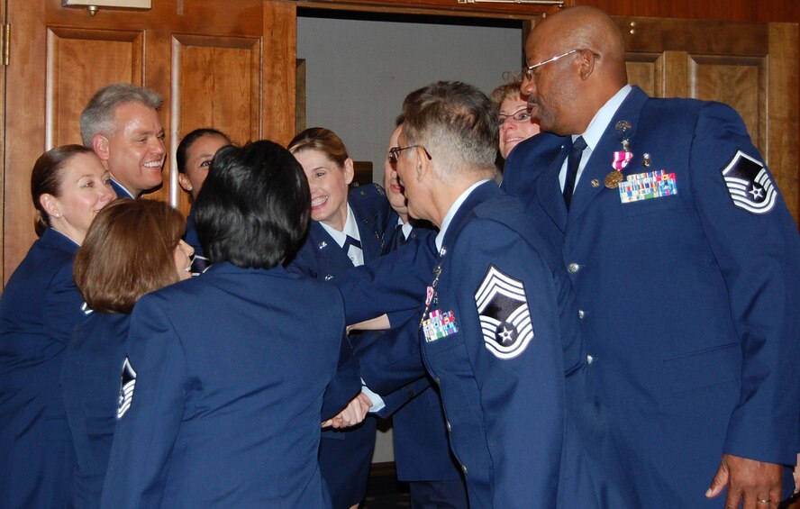 OFFUTT AIR FORCE BASE, Neb.  Ten 710th Medical Squadron retirees and Col. Joan Gonzalez, 710th MDS commander, gather for a celebratory huddle before joining their families for a retirement reception Oct. 3 at the Patriot Club.  The 10 MDS members retired during the event with a total of more than 250 years in the U.S. Air Force. U.S. Air Force photo by Debbie Aragon