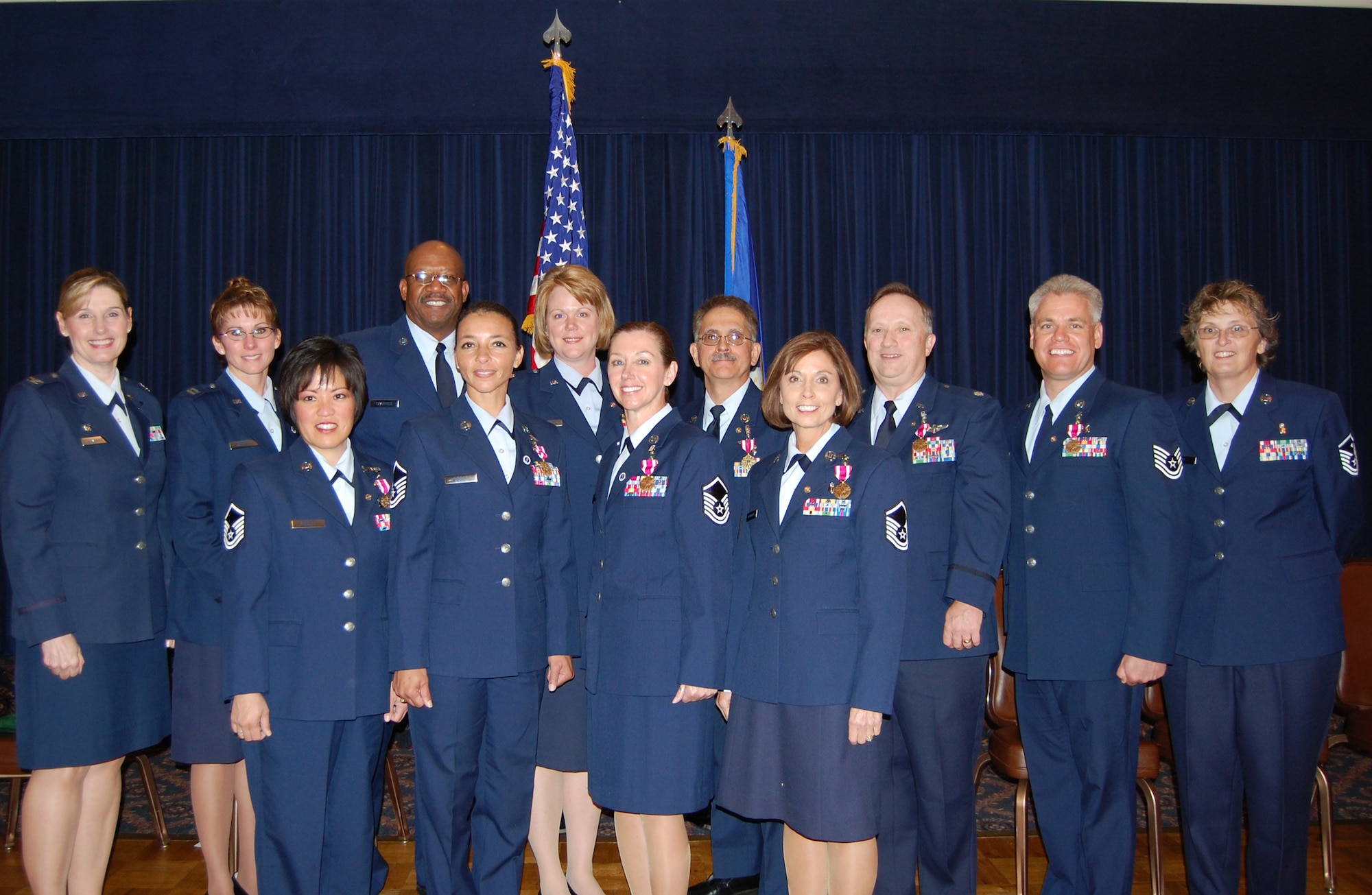 OFFUTT AIR FORCE BASE, Neb.  Ten 710th Medical Squadron retirees and their commander and first sergeant pose for a group photo following a mass retirement ceremony Oct. 3 at the Patriot Club. Back from left: 710th MDS Commander Col. Joan Gonzalez, Capt. Kami L. Willett, Master Sgt. Jeffrey J. Sparrock, Lt. Col. Shelly R. Kinney, Chief Master Sgt. Steven J. Gambaiana, Lt. Col. Howard E. Phillippi, Tech. Sgt. John A. Yonkers , 710th MDS First Sergeant Kelly Kay. Front from left: Master Sgt. Audrey L. Bennett, Master Sgt. Anna L. Sewell, Master Sgt. Jean F. Tait and Master Sgt. Debra A. Bernhardt pose for a group photo.  Between them, the retirees served more than 250 years in the U.S. Air Force. U.S. Air Force photo by Debbie Aragon