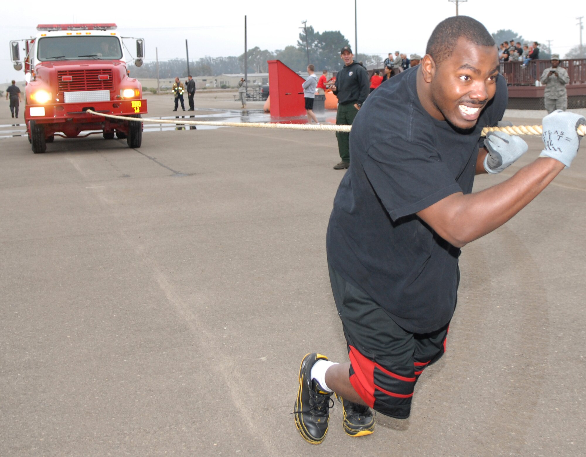 VANDENBERG AIR FORCE BASE, Calif. --Staff Sgt. Jeffery Watts, from the 30th Civil Engineer Squadron, pulls a fire truck by rope with the help of his five man team during the 3rd Annual Fire Muster competition here Oct. 9. The competition is held every year to educate and demonstrate firefightering skills. (U.S. Air Force photo/Airman 1st Class Kerelin Molina)

