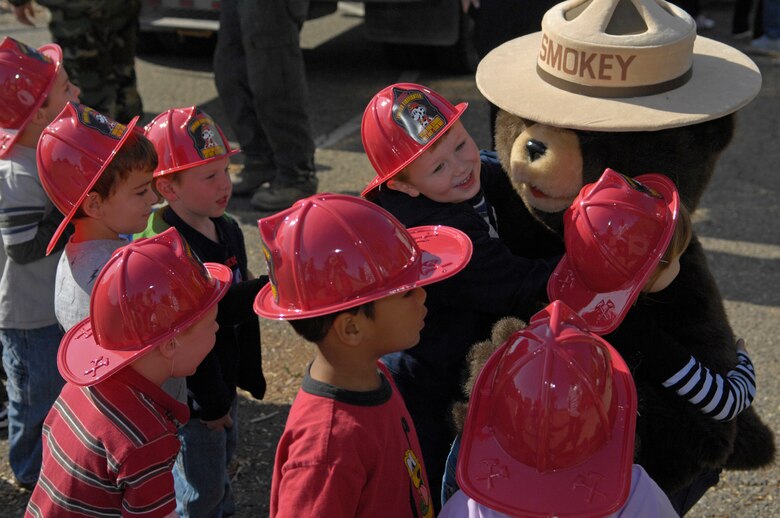 VANDENBERG AIR FORCE BASE, Calif. -- Smokey the Bear shares his bear hugs with a group of children  during his visit to the Child Development Center during Fire Prevention Week here Oct. 7. Fire Vandenberg Fire celebrated Fire Prevention Week by hosting a number of fire-related events. (U.S. Air Force photo/Airman 1st Class Andrew Lee) 