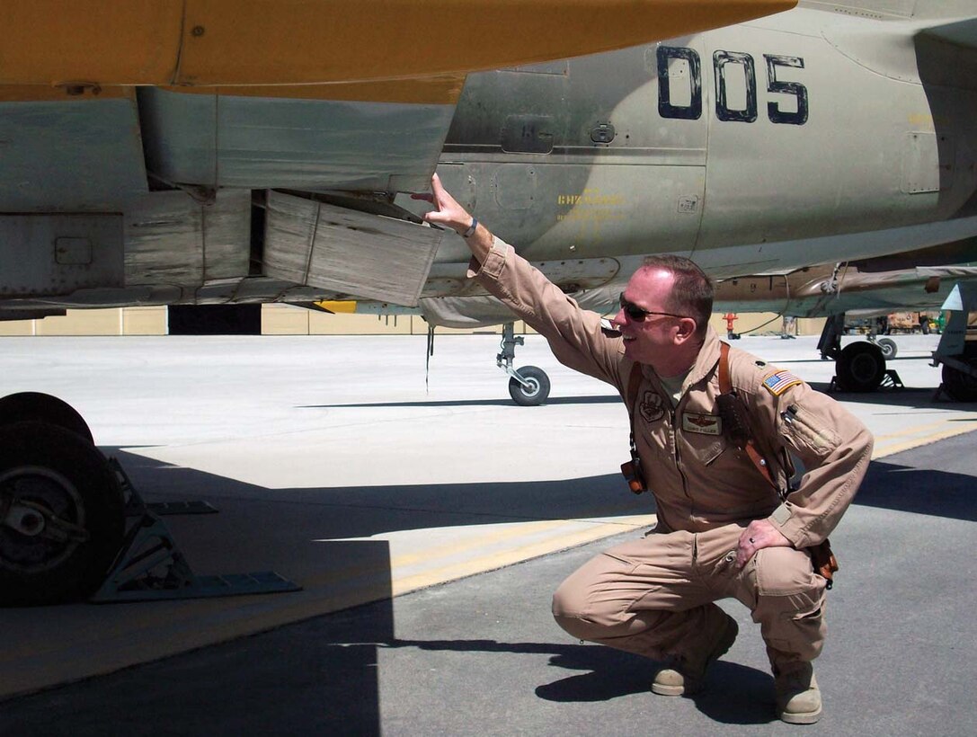Joint Team Andrews own Lt. Col. Chris Fuller, 99th Airlift Squadron pilot serving with the Combined Air Power Transition Force in Afghanistan, performs a visual inspection on an L-39 Albatross belonging to the Afghan National Army Air Corps before it is sent to a depot for an overhaul in Kabul, Afghanistan recently. (Courtesy photo)