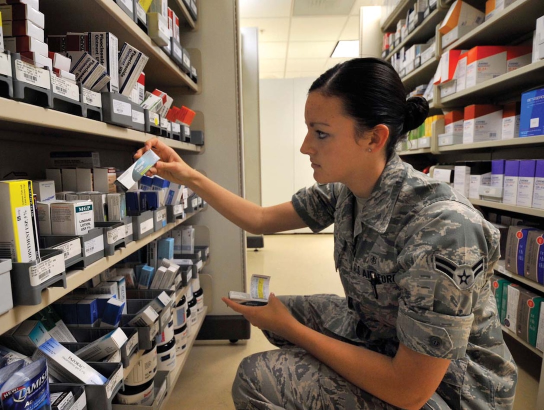 Airman 1st Class Kenda Gallo, 779th Medical Support Squadron pharmacy technician, looks for the correct medicine while refilling a prescription at the main pharmacy in Malcolm Grow Medical Center recently. The main pharmacy fills approximately 500 prescriptions daily, attributing to the 1,500 filled by the 779th Medical Group pharmacies each and every day. (U.S. Air Force photo/ Staff Sgt. Renae L. Kleckner)