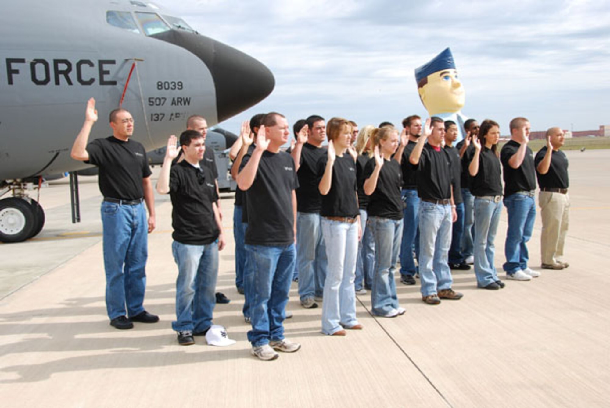 Twenty-nine people assembled on the flightline recently to enlist in the U.S. Air Force Reserve.  The new Airmen will become members of the 507th Air Refueling Wing here at Tinker Air Force Base.  Family members gathered around to watch the ceremony as 507th ARW Wing Commander, Col Jeffrey R. Glass helped them recite their Oath of Enlistment.