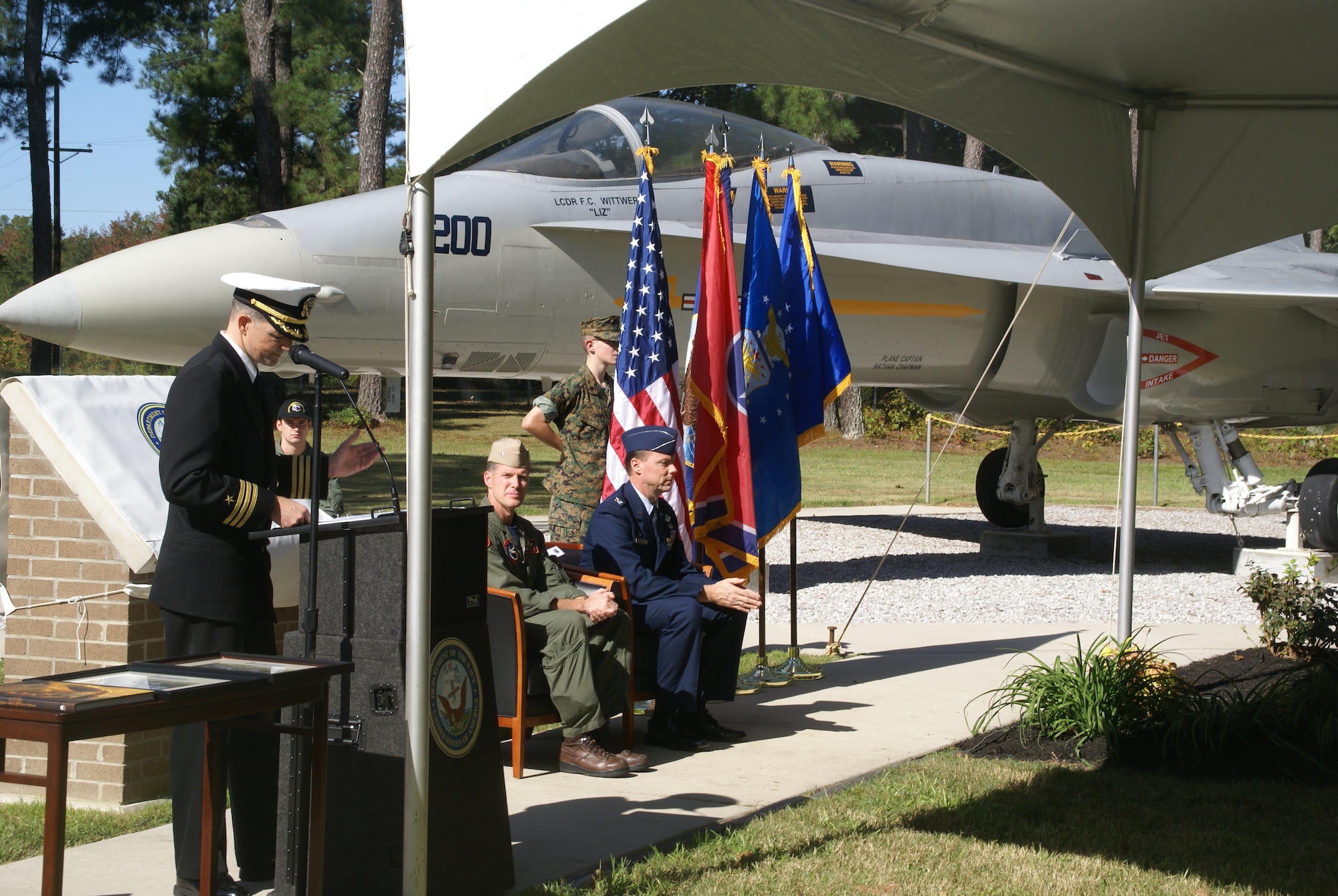 Navy Cmdr. Steven Kroll, the 704th Test Systems Group deputy director, addresses those attending a dedication ceremony of the F/A-18A Hornet display aircraft at Arnold Engineering Development Center in honor of Lt. Cmdr. Frank Wittwer, who last served with VFA-97, also home based at NAS Lemoore. On Jan. 18, 2006, Lieutenant Commander Wittwer died while flying on a night-time training exercise over California in preparation for deployment overseas. AEDC Commander Col. Michael Panarisi, who has flown aboard more than 39 aircraft as a master navigator, introduced Commander Wilson to those attending the dedication ceremony. (Photo by Philip Lorenz III)