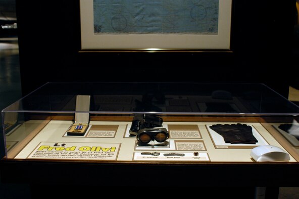 DAYTON, Ohio -- Lt. Fred Olivi exhibit in the World War II Gallery at the National Museum of the U.S. Air Force. These items were carried by Olivi, third pilot on the B-29 "Bockscar", on the atomic bomb mission against Nagasaki. Exhibit features such items as Olivi's Distinguished Flying Cross, pistol and gloves. (U.S. Air Force photo)