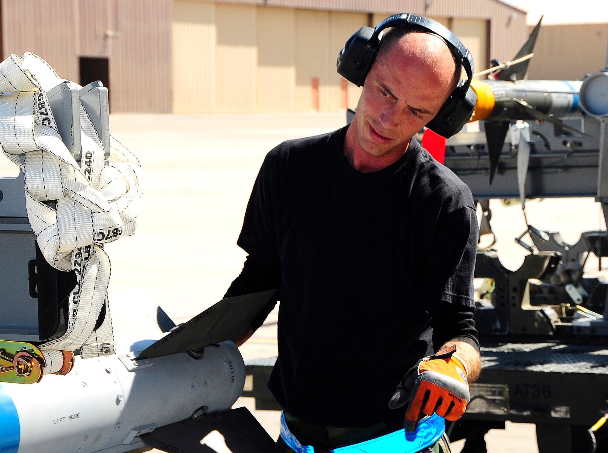 HOLLOMAN AIR FORCE BASE, N.M. -- Staff Sgt. Christopher Ayers, 49th Aircraft Maintenance Squadron, simulates the loading of a missile onto an F-22A Raptor during a Phase 1 exercise here Oct. 7. During the exercise, all of Team Holloman was called forth to demonstrate the ability to reposition it’s assets here. (U.S. Air Force photo by Tech. Sgt. Chris Flahive)