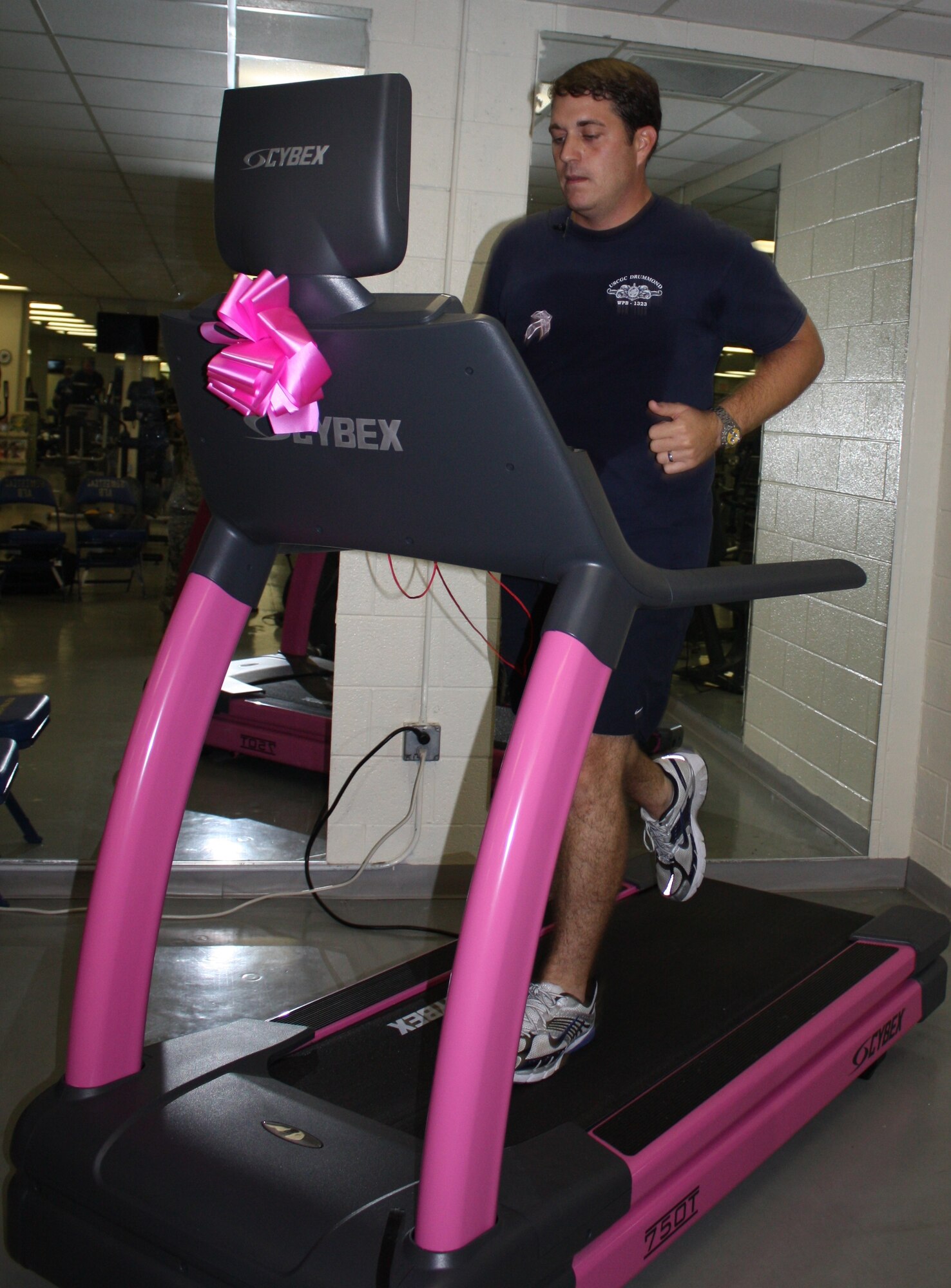 U.S. Coast Guard Petty Officer 1st Class Francis Kinsey of the Cutter Drummond Unit in Miami Beach, Fla. strides along on a pink treadmill to raise money for breast cancer research and education at the Sam Johnson Fitness Center at Homestead Air Reserve Base Oct.8. (U.S. Air Force photo/Senior Airman Katie Spencer)
