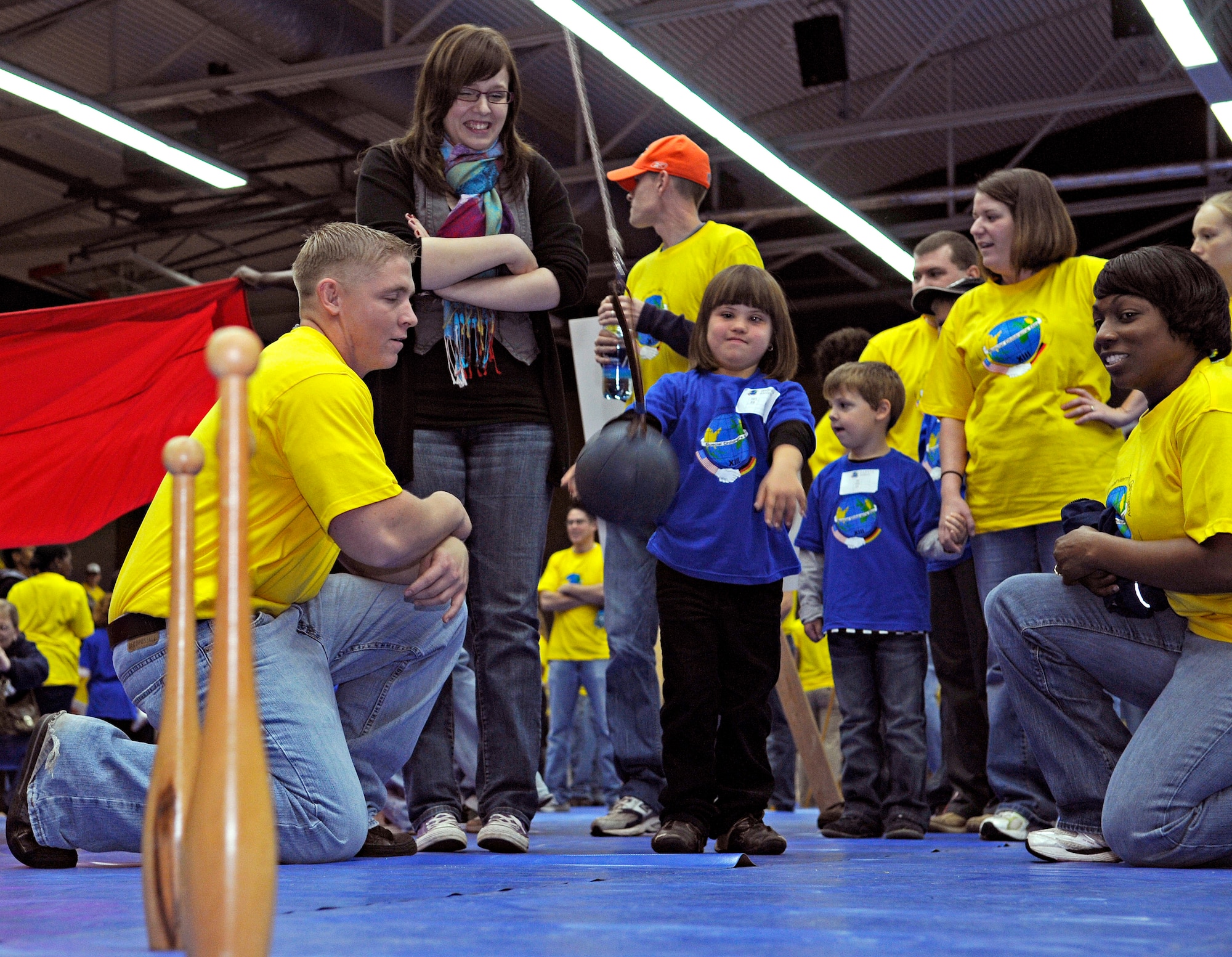SPANGDAHLEM AIR BASE, Germany – Jennifer Erschfeld throws a tethered ball at bowling pins whiles volunteers cheer her on Oct. 8. Jennifer was one of about 100 children with special needs from Bitburg’s St. Martin’s School and Department of Defense Dependants Schools-Europe to attend the Special Children’s Day held at the Skelton Memorial Fitness Center. The event required about 200 volunteers to help the children with games, lunch and an award ceremony at the end. (U.S. Air Force photo/Senior Airman Benjamin Wilson)