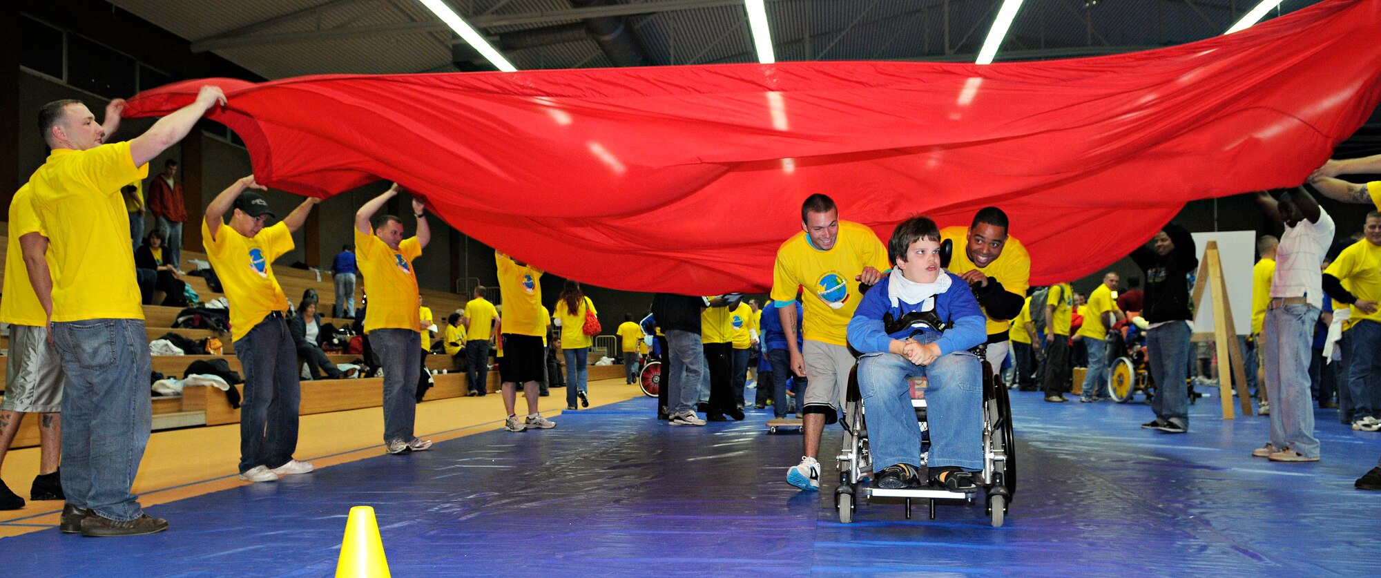 SPANGDAHLEM AIR BASE, Germany – Volunteers help Thomas Brück complete a roller-board obstacle Oct. 8. Thomas was one of about 100 children with special needs from Bitburg’s St. Martin’s School and Department of Defense Dependants Schools-Europe to attend the Special Children’s Day held at the Skelton Memorial Fitness Center. The event required about 200 volunteers to help the children with games, lunch and an award ceremony at the end. (U.S. Air Force photo/Senior Airman Benjamin Wilson)