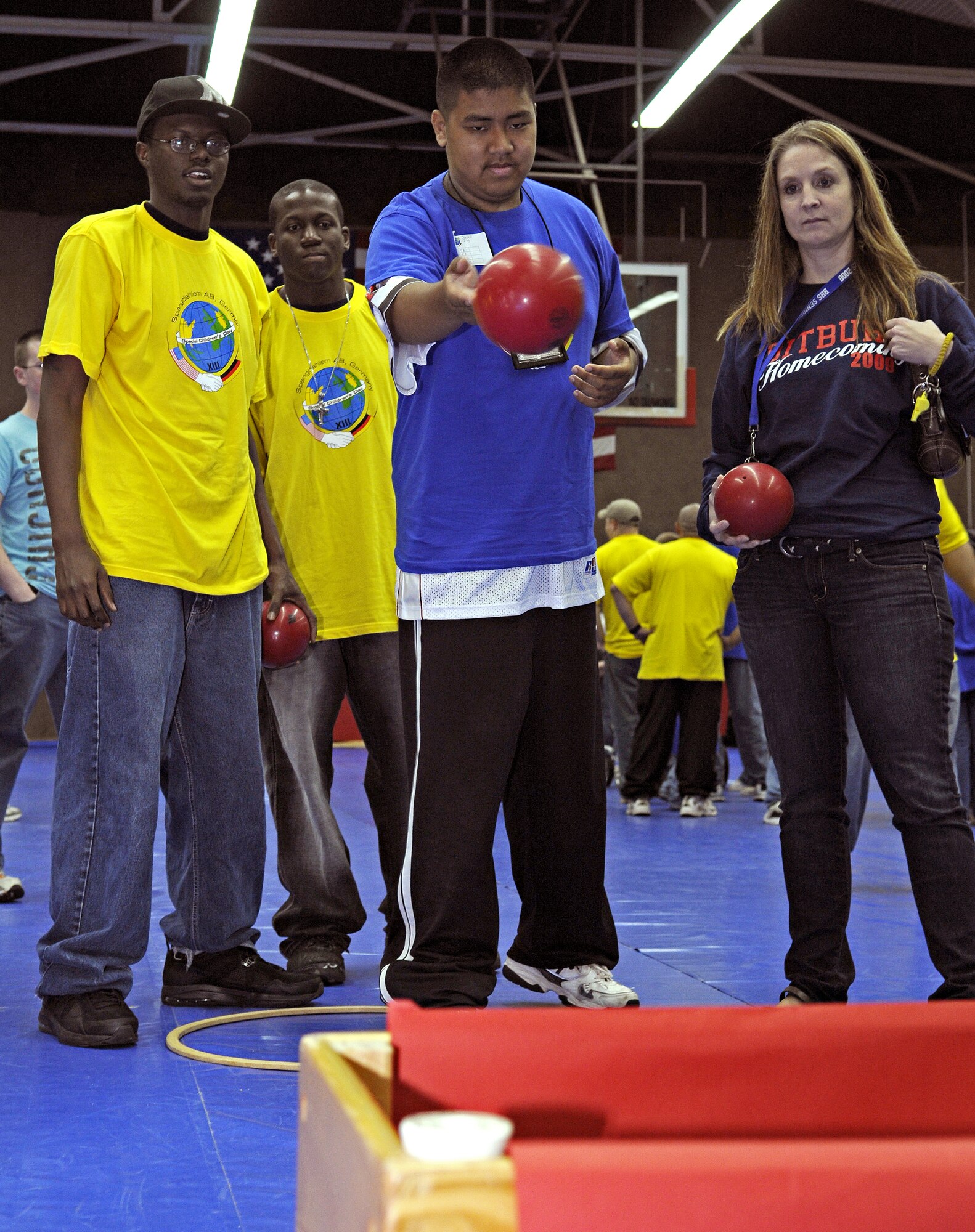 SPANGDAHLEM AIR BASE, Germany – Jarrell Ilog, son of Master Sgt. Gerardo Ilog, attempts to toss as many balls as he can into a bin within a minute Oct. 8. Jarrell was one of about 100 children with special needs from Bitburg’s St. Martin’s School and Department of Defense Dependants Schools-Europe to attend the Special Children’s Day held at the Skelton Memorial Fitness Center. The event required about 200 volunteers to help the children with games, lunch and an award ceremony at the end. (U.S. Air Force photo/Senior Airman Benjamin Wilson)