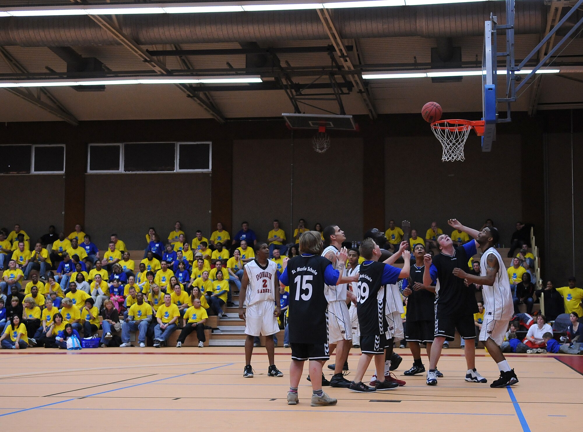 SPANGDAHLEM AIR BASE, Germany – Players from the St. Martin’s School and the Spangdahlem Sabers men’s basketball team go for the rebound during a basketball game here Oct. 8 at the fitness center. The basketball game was a friendly match between the two teams during the Special Children’s Day events. (U.S. Air Force photo/Airman 1st Class Nathanael Callon)