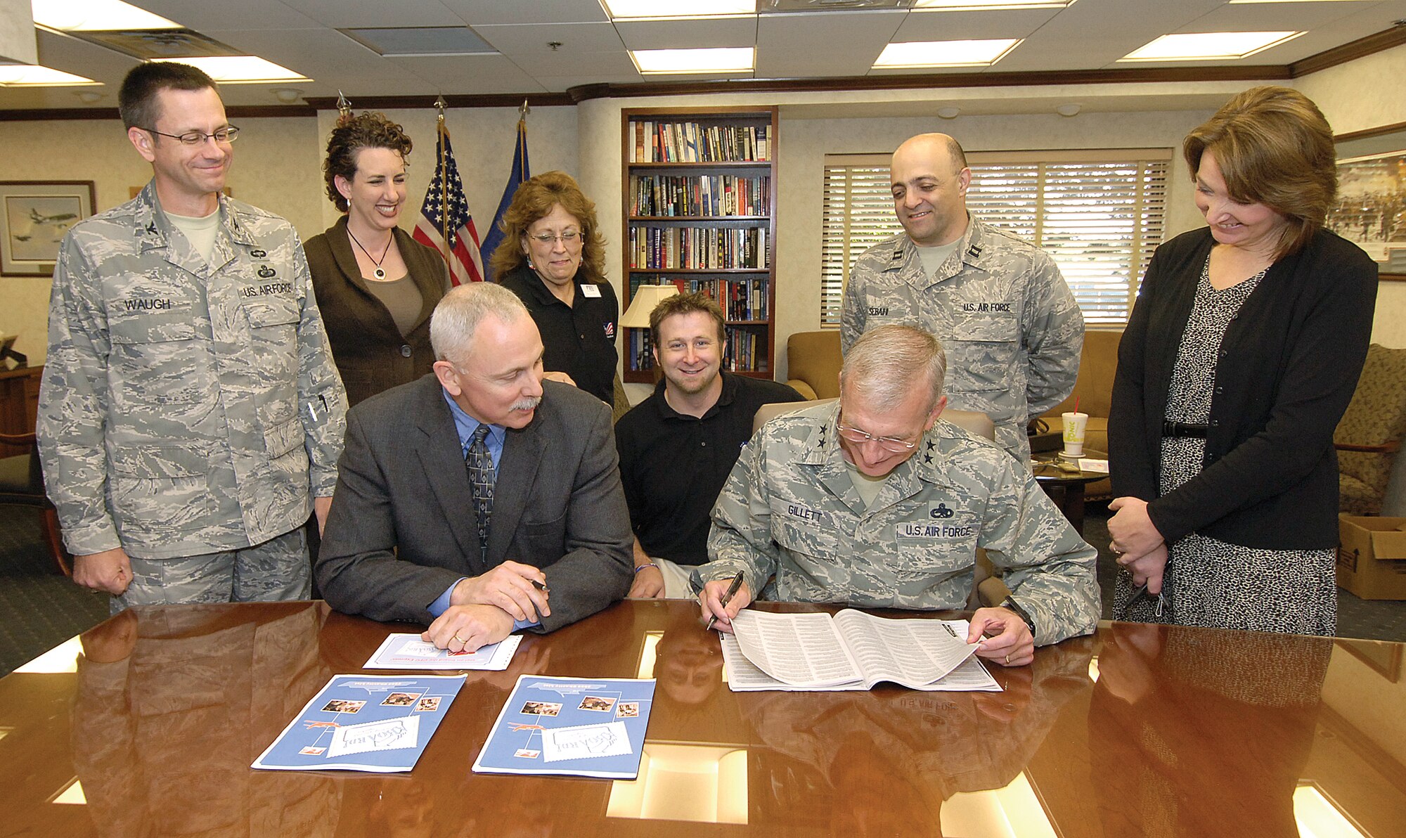 The Combined Federal Campaign kicked off Oct. 7 and will run through Nov. 13. From left: Col. Paul Waugh, Oklahoma City Air Logistics Center vice commander; Mindy Banz, CFC director; John Over, OC-ALC executive director; Melba Smith, CFC loaned executive; Tim Eldridge, CFC loaned executive; Maj. Gen. David Gillett, OC-ALC commander; Capt. Sam Sebaihi, CFC loaned executive and Laura Culberson, OC-ALC chief of staff; look over the CFC charity list as the ALC leaders prepare to fill out pledge forms. (Air Force photo by Margo Wright)