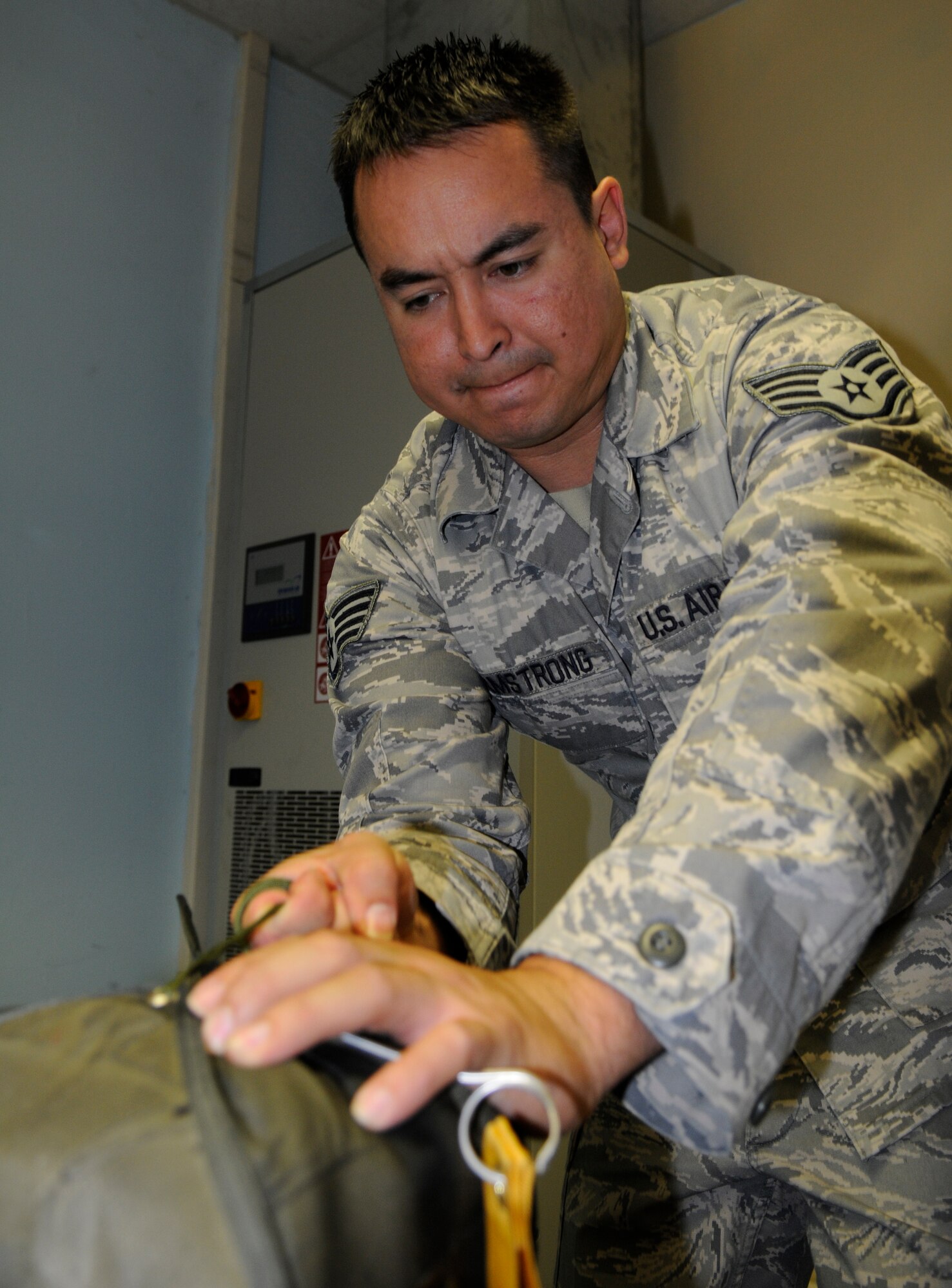SPANGDAHLEM AIR BASE, Germany – Staff Sgt. Ronald Armstrong, 52nd Operations Support Squadron aircrew flight equipment technician, closes the flaps to a pilot chute Oct. 6. The aircrew flight equipment flight at Spangdahlem is responsible for maintaining about 90 F-16 Fighting Falcon and 27 A-10 Thunderbolt II parachutes. (U.S. Air Force photo/Senior Airman Benjamin Wilson)