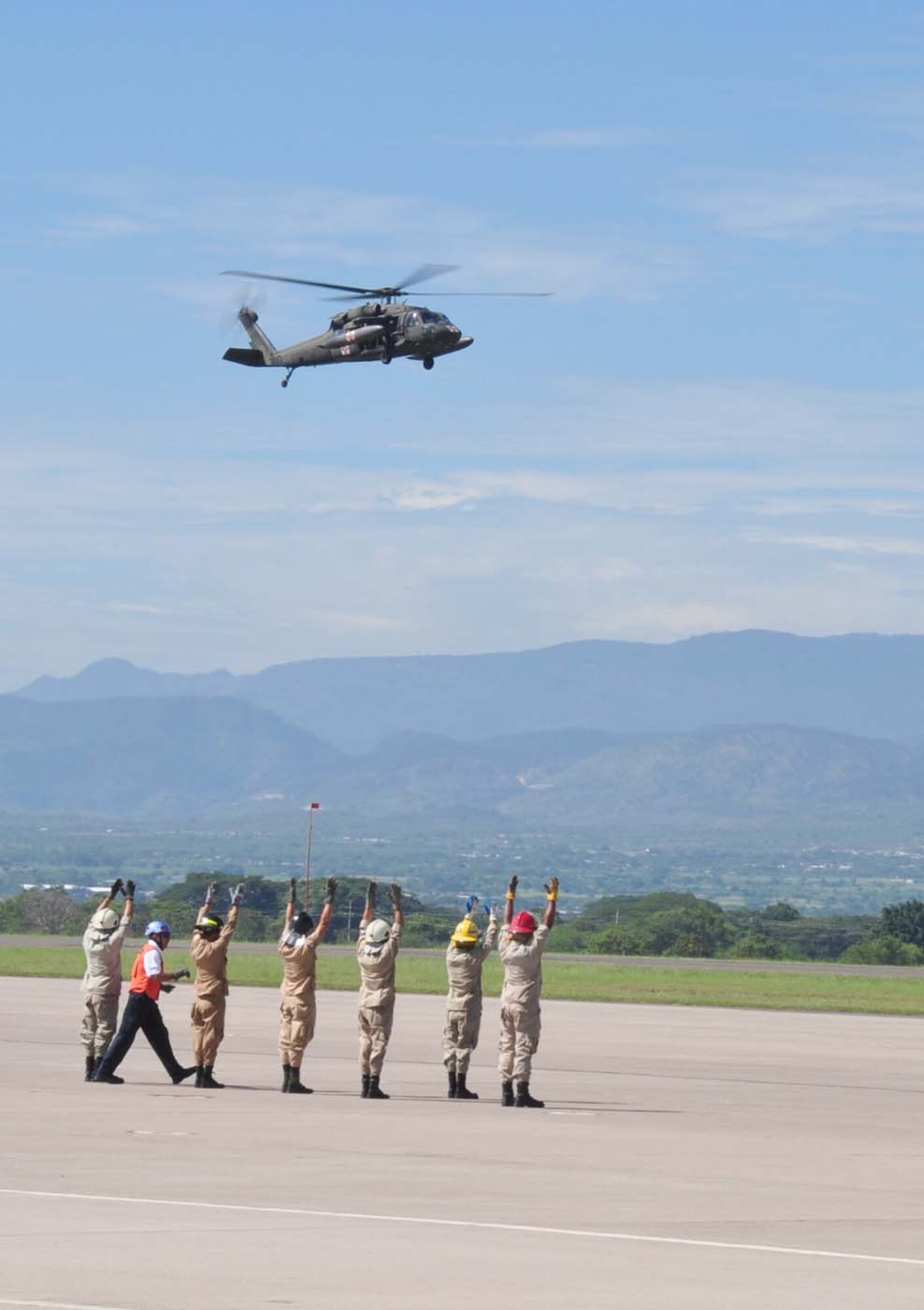 SOTO CANO AIR BASE, Honduras — A group of 24 Honduran firefighters practice loading, unloading and arm signals during the litter training Oct. 7 at the base flightline. The JTF-Bravo firefighters and 228th Aviations Regiment worked with the Honduran firefighters to bring them up to speed on different aircraft procedures used here in case the firefighters ever have to work together in the local community. Some of the training included litter training, aircraft training and general firefighter safety and procedures (U.S. Air Force photo/Staff Sgt. Chad Thompson).