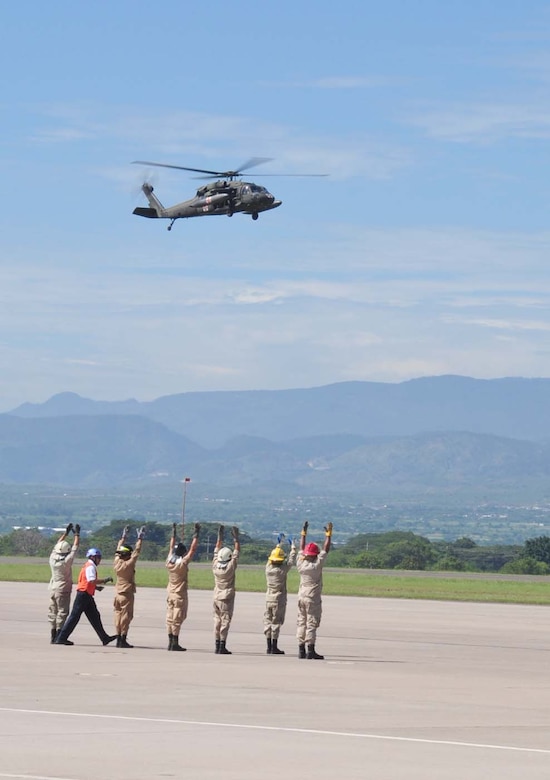 SOTO CANO AIR BASE, Honduras — A group of 24 Honduran firefighters practice loading, unloading and arm signals during the litter training Oct. 7 at the base flightline. The JTF-Bravo firefighters and 228th Aviations Regiment worked with the Honduran firefighters to bring them up to speed on different aircraft procedures used here in case the firefighters ever have to work together in the local community. Some of the training included litter training, aircraft training and general firefighter safety and procedures (U.S. Air Force photo/Staff Sgt. Chad Thompson).