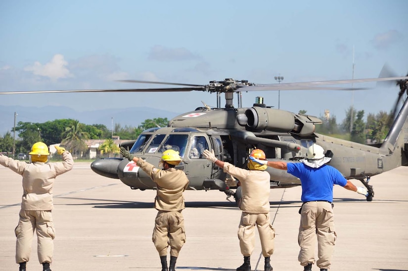 SOTO CANO AIR BASE, Honduras — A group of 24 Honduran firefighters practice loading, unloading and arm signals during the litter training Oct. 7 at the base flightline. The JTF-Bravo firefighters and 228th Aviations Regiment worked with the Honduran firefighters to bring them up to speed on different aircraft procedures used here in case the firefighters ever have to work together in the local community. Some of the training included litter training, aircraft training and general firefighter safety and procedures (U.S. Air Force photo/Staff Sgt. Chad Thompson).