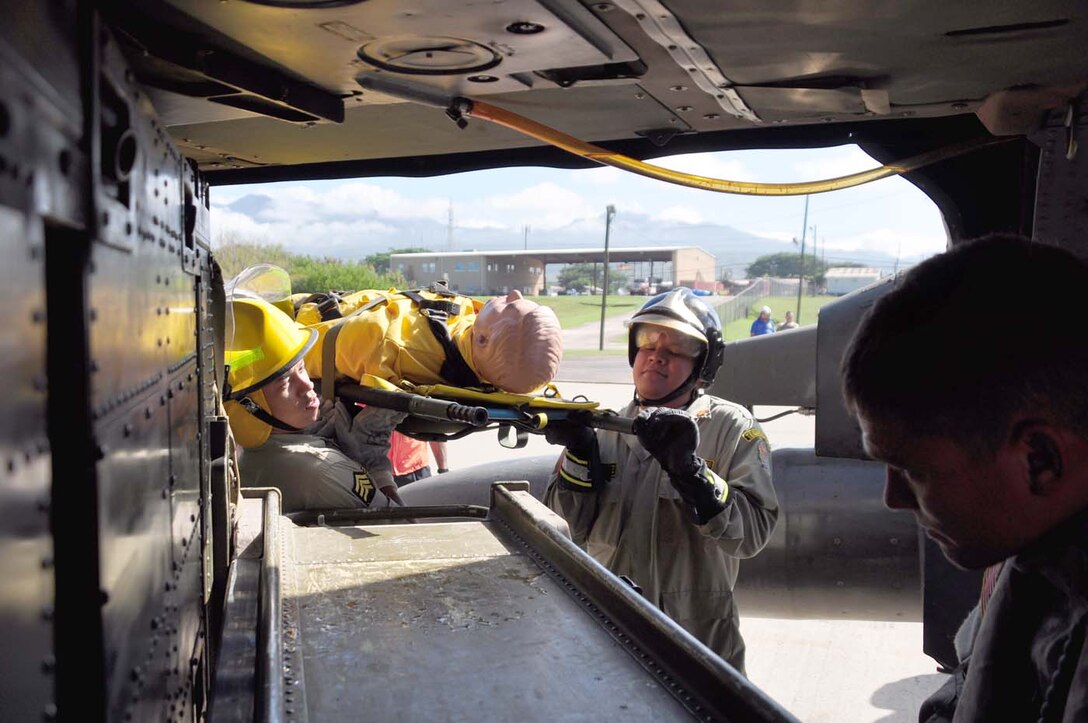 SOTO CANO AIR BASE, Honduras — A group of 24 Honduran firefighters practice loading, unloading and arm signals during the litter training Oct. 7 at the base flightline. The JTF-Bravo firefighters and 228th Aviations Regiment worked with the Honduran firefighters to bring them up to speed on different aircraft procedures used here in case the firefighters ever have to work together in the local community. Some of the training included litter training, aircraft training and general firefighter safety and procedures (U.S. Air Force photo/Staff Sgt. Chad Thompson).