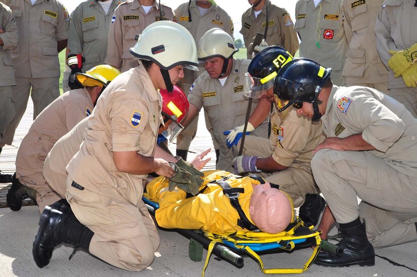 SOTO CANO AIR BASE, Honduras — A group of 24 Honduran firefighters practice loading, unloading and arm signals during the litter training Oct. 7 at the base flightline. The JTF-Bravo firefighters and 228th Aviations Regiment worked with the Honduran firefighters to bring them up to speed on different aircraft procedures used here in case the firefighters ever have to work together in the local community. Some of the training included litter training, aircraft training and general firefighter safety and procedures (U.S. Air Force photo/Staff Sgt. Chad Thompson).