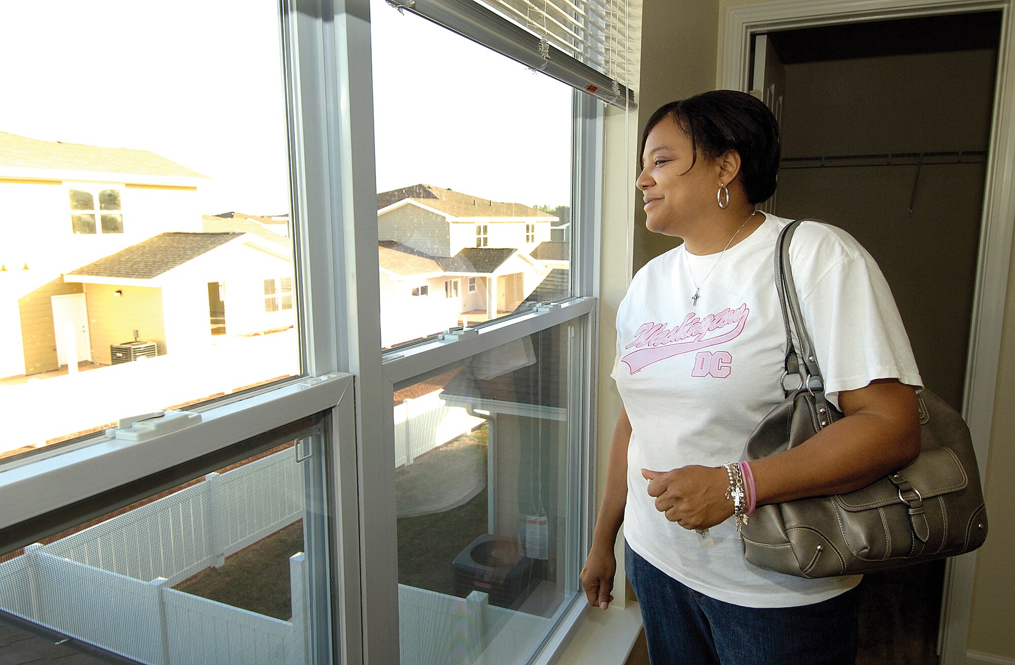 Felicea Winrow takes her first look out a bedroom window of her new home on Blackbird Drive Oct. 1, a newly-opened Tinker housing area by the Scissortail Trail.  “I’m so excited!” she said as she looked through each room.  The Winrow family was one of several who got the keys to their new homes on Blackbird that day. As progress continues, more families will transition into new homes. (Air Force photo by Margo Wright)
