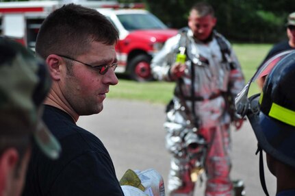 SOTO CANO AIR BASE, Honduras — Senior Airman Nicholas Fox (right) points out different pieces of safety equipment while Tech. Sgt. Clive Chipman explains to the Honduran firefighters what some of the equipment is used for Oct. 6 at the Soto Cano burn house. The JTF-Bravo firefighters worked with the Honduran firefighters to bring them up to speed on different procedures used here in case the firefighters ever have to work together in the local community. Some of the training included litter training, aircraft training and general firefighter safety and procedures (U.S. Air Force photo/Staff Sgt. Chad Thompson).