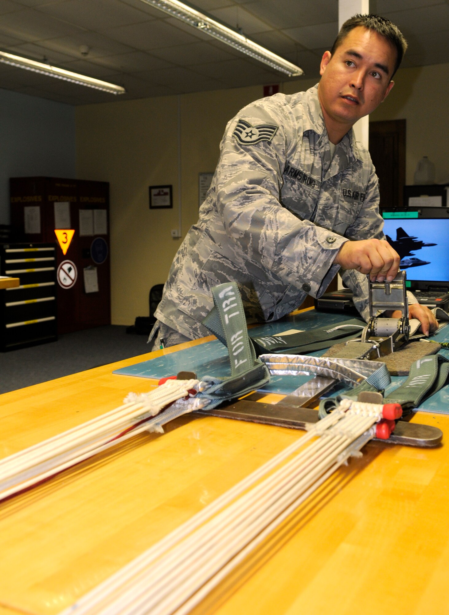 SPANGDAHLEM AIR BASE, Germany – Staff Sgt. Ronald Armstrong, 52nd Operations Support Squadron aircrew flight equipment technician, applies tension to the lines of a training parachute before it is packed Oct. 6. Tension must be applied to the lines to ensure they are in the proper order. (U.S. Air Force photo/Senior Airman Benjamin Wilson)