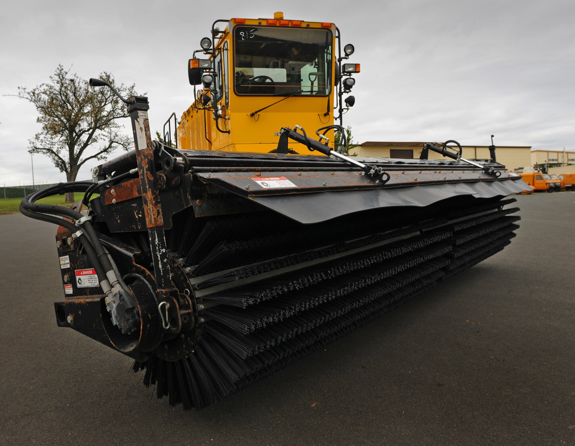 SPANGDAHLEM AIR BASE, Germany -- An Oshkosh snow vehicle with mounted broom sits for display Oct. 9 at the 52nd Civil Engineer Squadron Pavements and Construction Shop. The vehicle and several smaller tractors are used to clear the airfield of snow. The vehicle has interchangeable parts, making it versatile depending on weather conditions. (U.S. Air Force photo/Airman 1st Class Nathanael Callon)