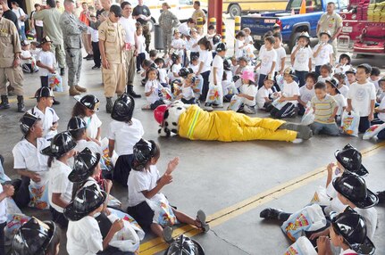 SOTO CANO AIR BASE, Honduras — “Sparky the fire dog” shows children how to stop, drop and roll Oct. 6 during the fire department’s fire prevention week. About 175 children from different schools in La Paz and Comayagua traveled to base to learn some important lessons about fire prevention. The children got to tour the fire house, watch several demonstrations on how firefighters fight fires and they got to meet “Sparky the fire dog.” Every year during the week of Oct. 8 fire stations around the country reach out to the community to remind families of the importance of fire prevention (U.S. Air Force photo/Staff Sgt. Chad Thompson).