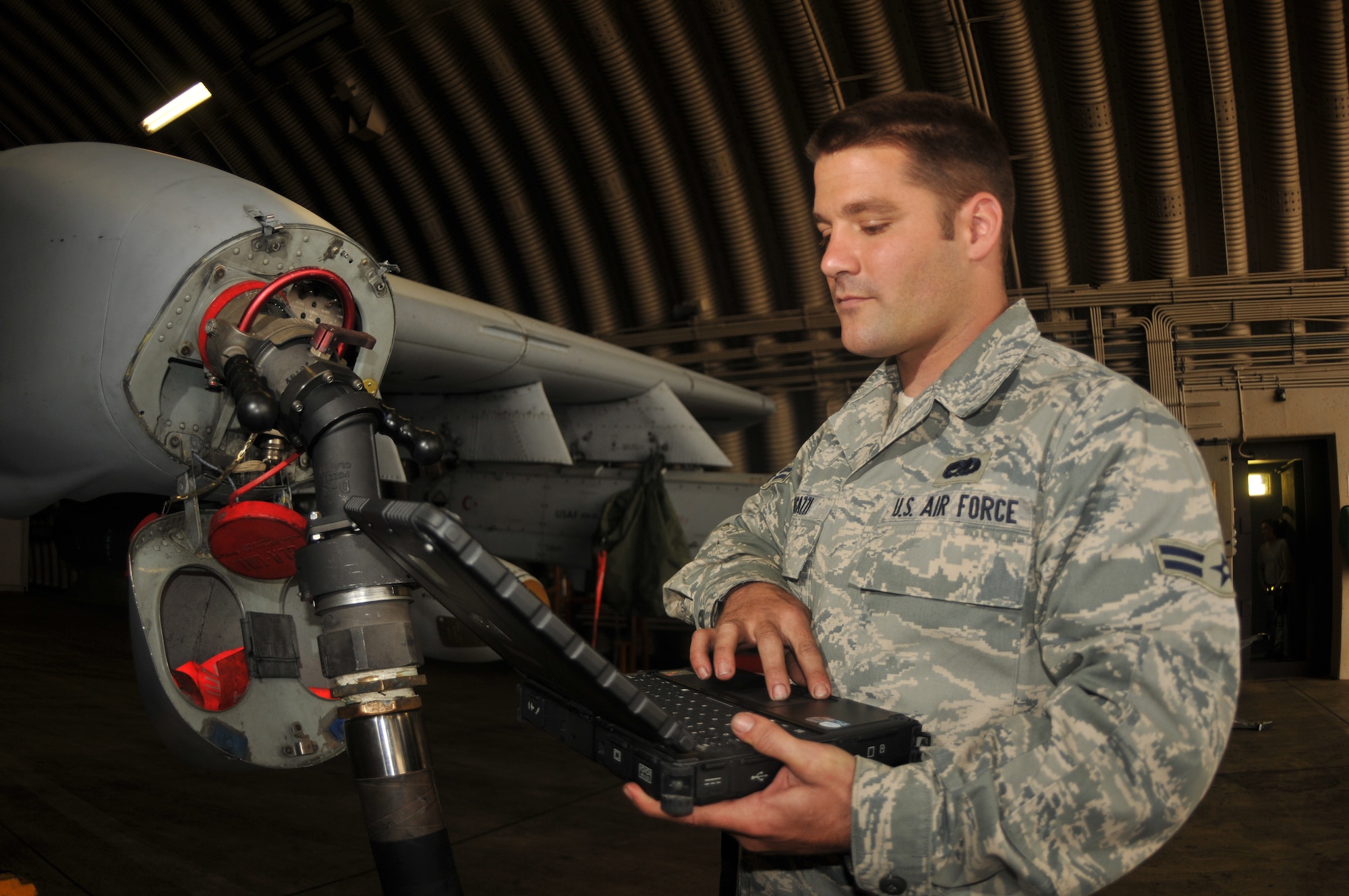 SPANGDAHLEM AIR BASE, Germany -- Airman 1st Class Dominick Fugazzi, 52nd Aircraft Maintenance Squadron, looks up  a technical order program on a laptop before loading fuel on an A-10 Thunderbolt II Oct. 3. Air Force crew chiefs ensure that their aircraft are fully loaded with fuel before take off as part of the pre-flight inspection. (U .S. Air Force photo/Airman 1st Class Nick Wilson)