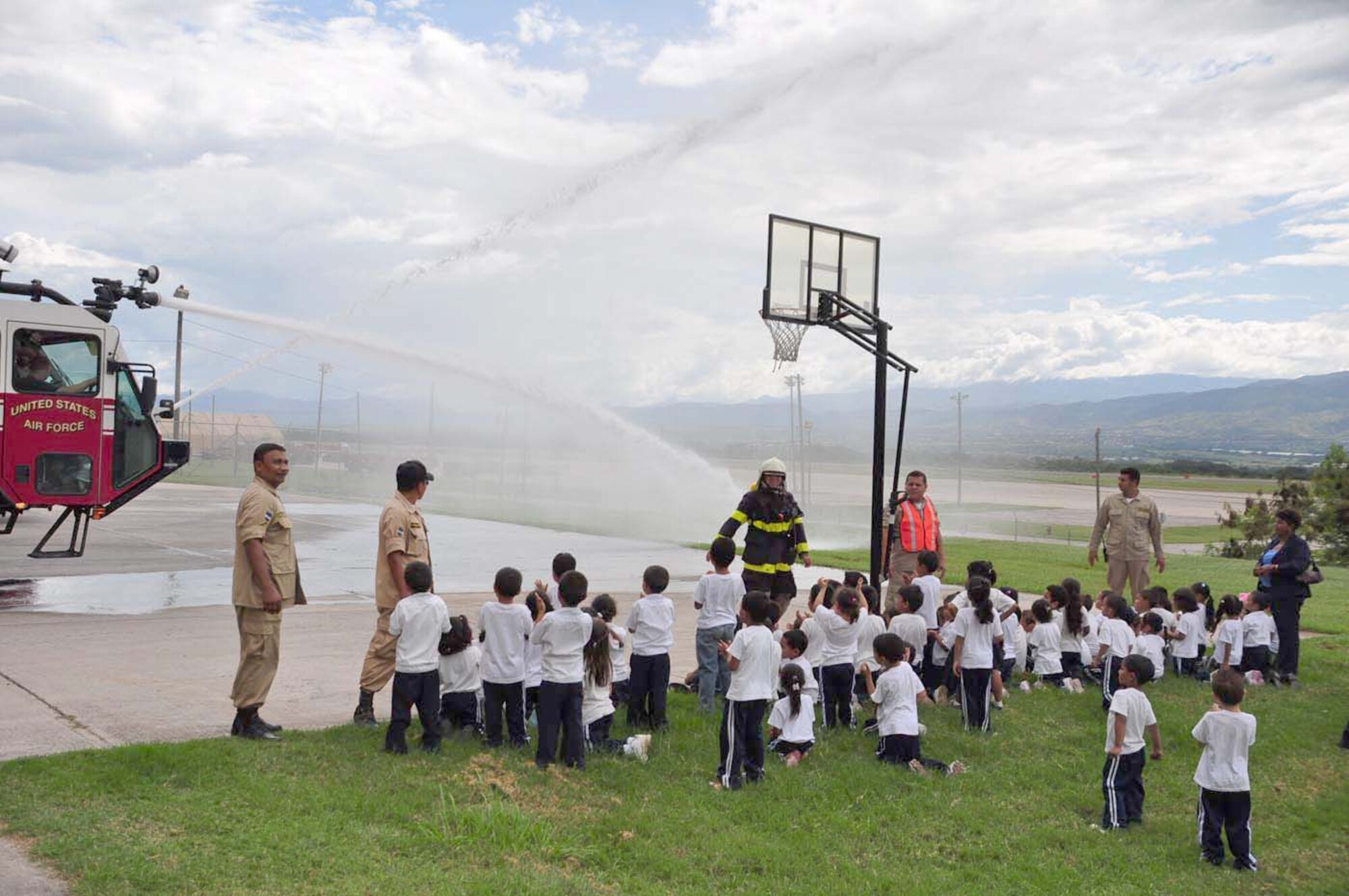 SOTO CANO AIR BASE, Honduras — Some children watch as firefighters from Soto Cano Air Base give them a demonstration of how their fire trucks can spray water Oct. 6 at the Joint Task Force-Bravo fire department. About 175 children from different schools in La Paz and Comayagua traveled to base to learn some important lessons about fire prevention. The children got to tour the fire house, watch several demonstrations on how firefighters fight fires and they got to meet “Sparky the fire dog.” Every year during the week of Oct. 8 fire stations around the country reach out to the community to remind families of the importance of fire prevention (U.S. Air Force photo/Staff Sgt. Chad Thompson).