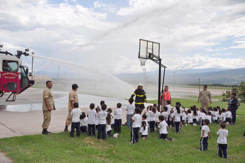 SOTO CANO AIR BASE, Honduras — Some children watch as firefighters from Soto Cano Air Base give them a demonstration of how their fire trucks can spray water Oct. 6 at the Joint Task Force-Bravo fire department. About 175 children from different schools in La Paz and Comayagua traveled to base to learn some important lessons about fire prevention. The children got to tour the fire house, watch several demonstrations on how firefighters fight fires and they got to meet “Sparky the fire dog.” Every year during the week of Oct. 8 fire stations around the country reach out to the community to remind families of the importance of fire prevention (U.S. Air Force photo/Staff Sgt. Chad Thompson).
