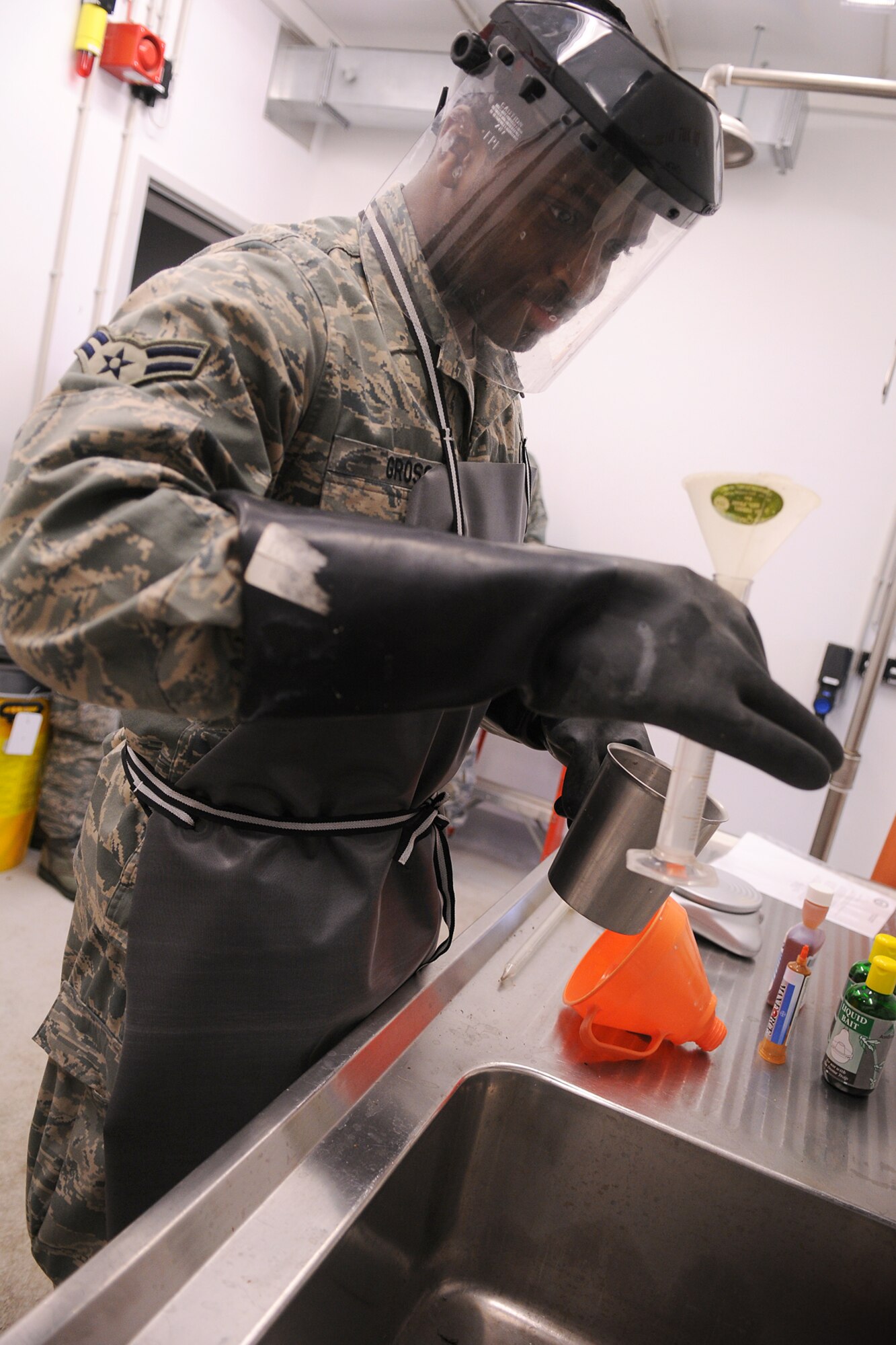 SPANGDAHLEM AIR BASE, Germany -- Airman 1st Class Antonio Gross, 52nd Civil Engineer Squadron entomology shop, mixes chemicals for a pesticide treatment to reduce the mosquito population on Perimeter Road here Oct. 6. The entomology shop is responsible for all rodent and pest control on the base. (U.S. Air Force photo/Airman 1st Class Nathanael Callon)